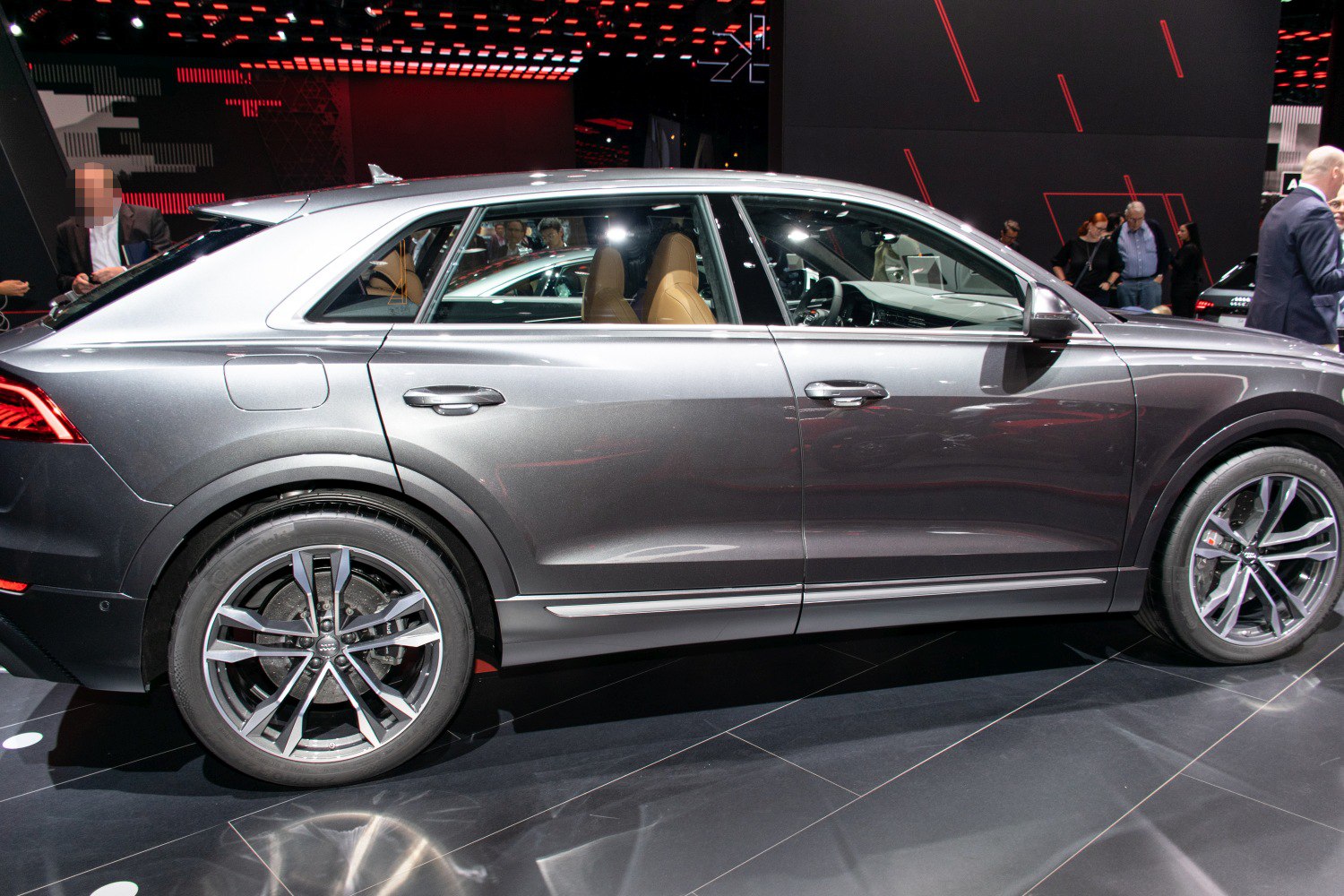 Side profile of a sleek luxury SUV with distinctive alloy wheels and premium design.