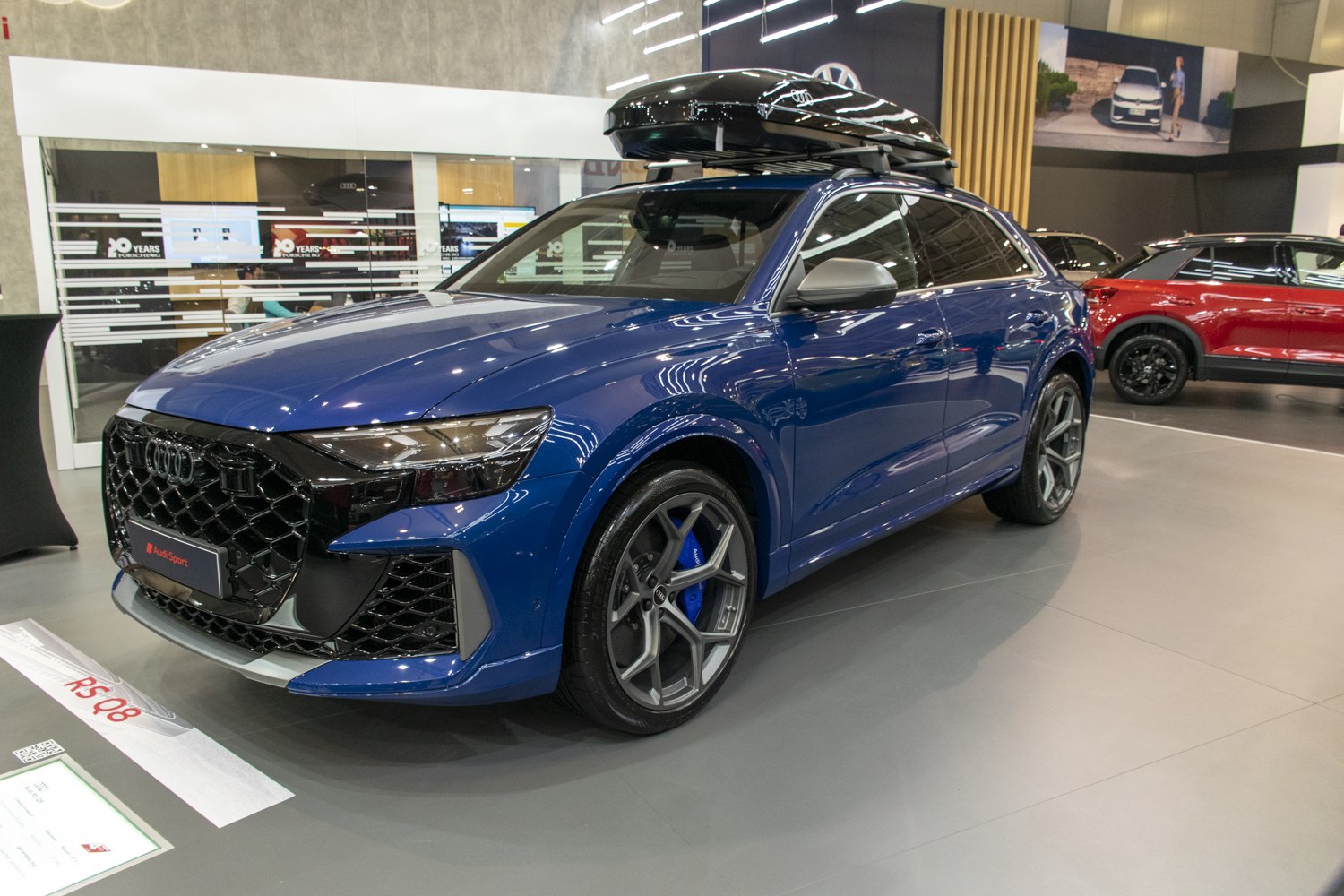 Blue SUV with black grille and roof cargo box
