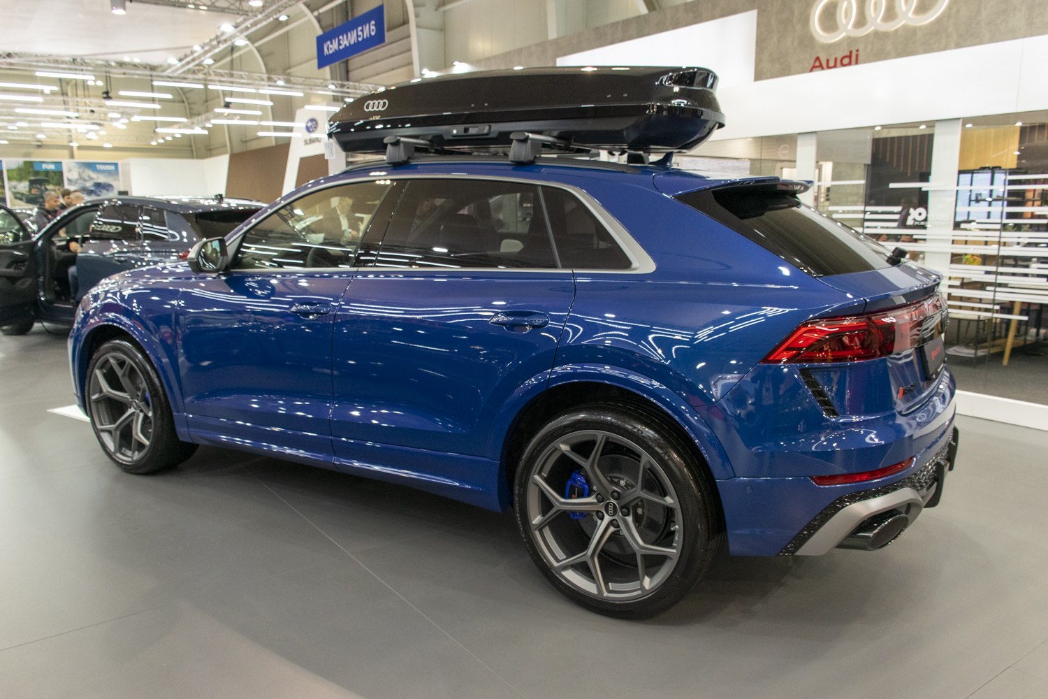 Sporty blue SUV with alloy wheels and roof cargo box