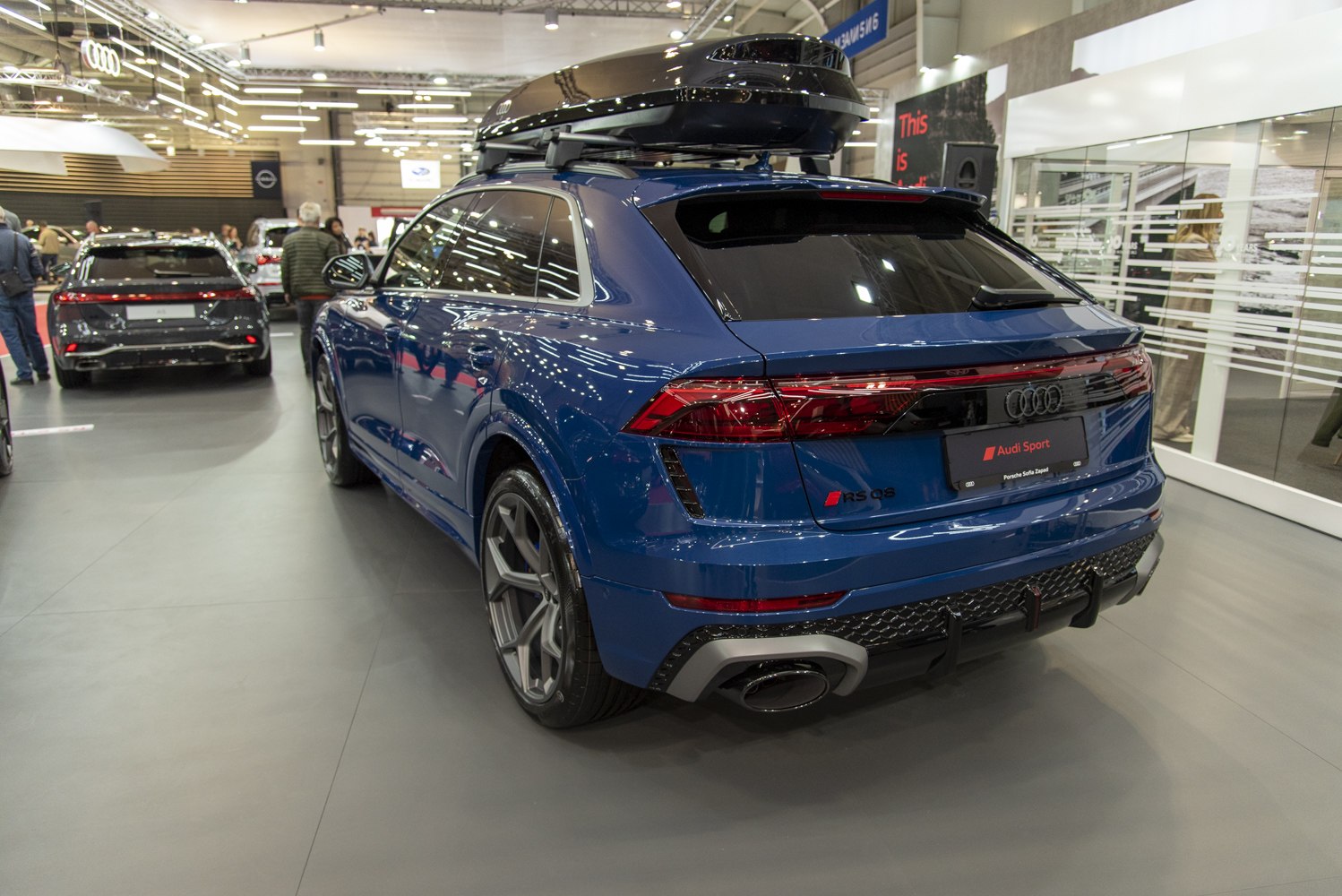 Rear view of sporty SUV with roof cargo box