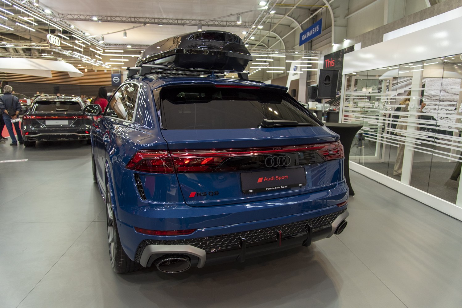 Rear view of SUV with LED taillights, dual exhaust, and rooftop cargo box