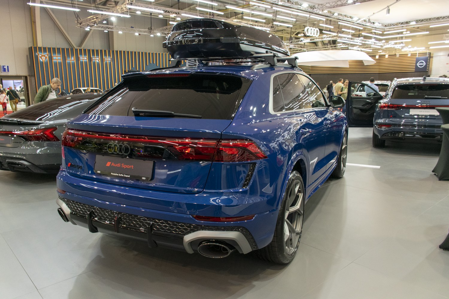 Rear view of SUV with roof cargo box and modern taillights