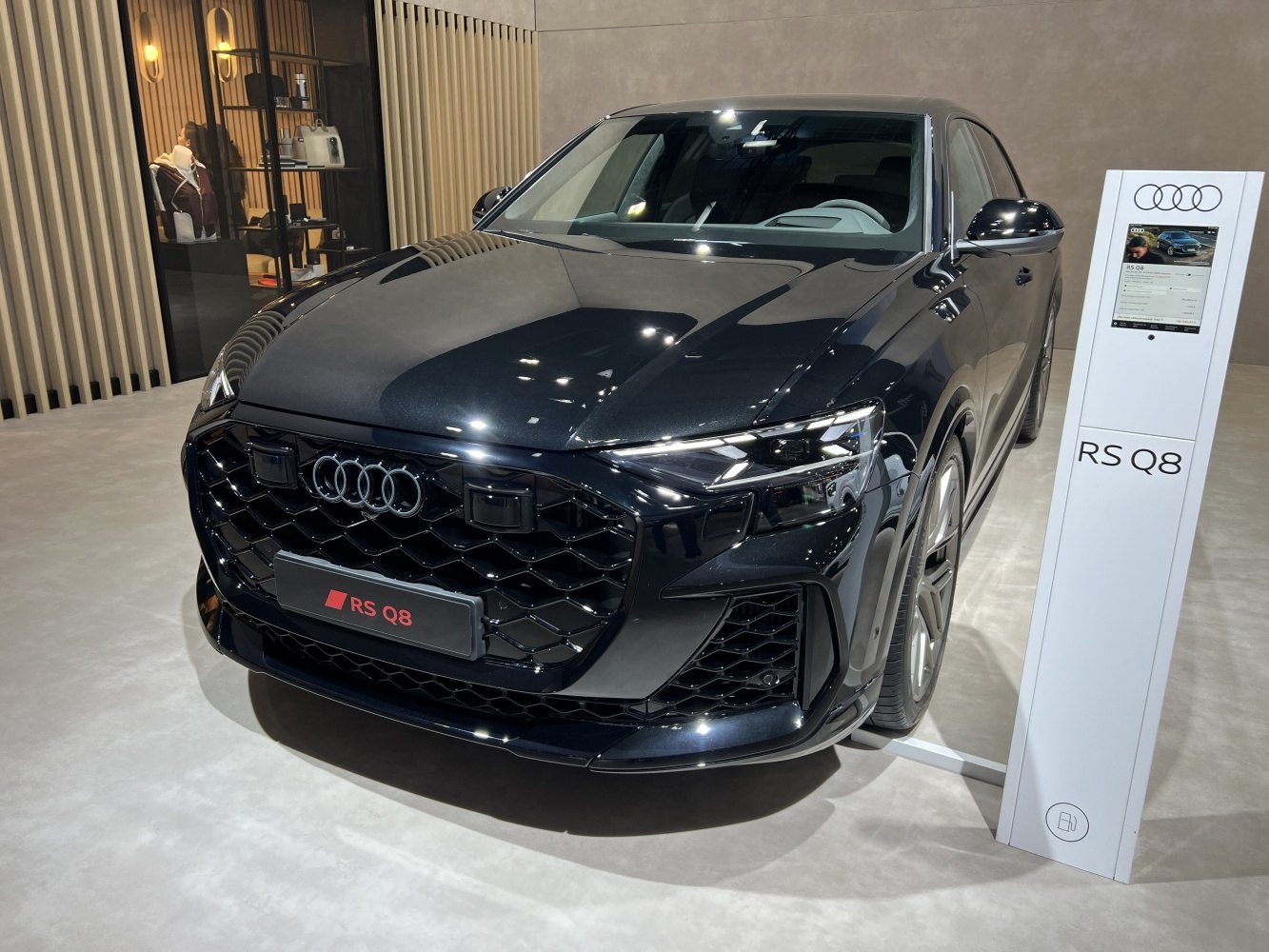 Black honeycomb grille with integrated LED headlights on modern SUV front.