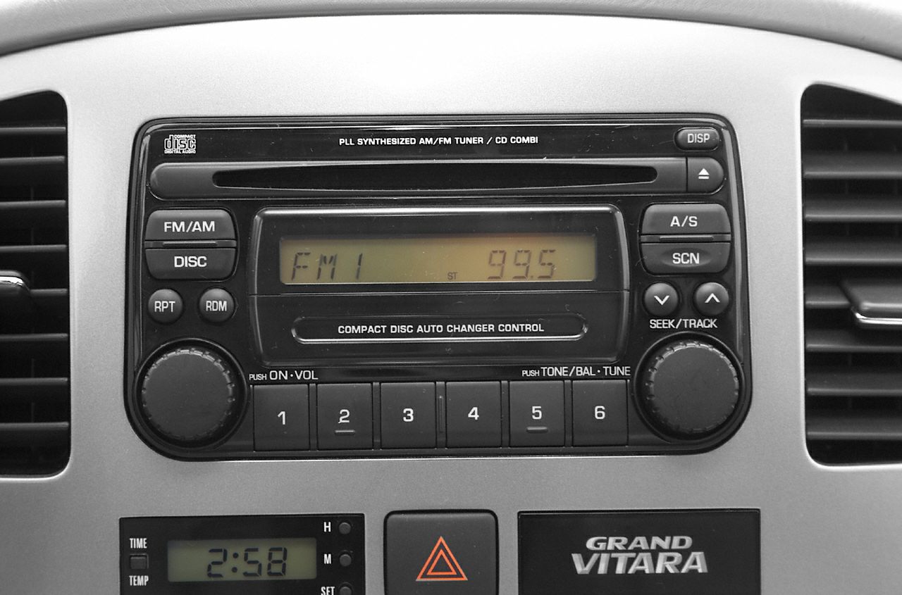 Vintage car radio and dashboard controls with FM/AM tuner and CD player