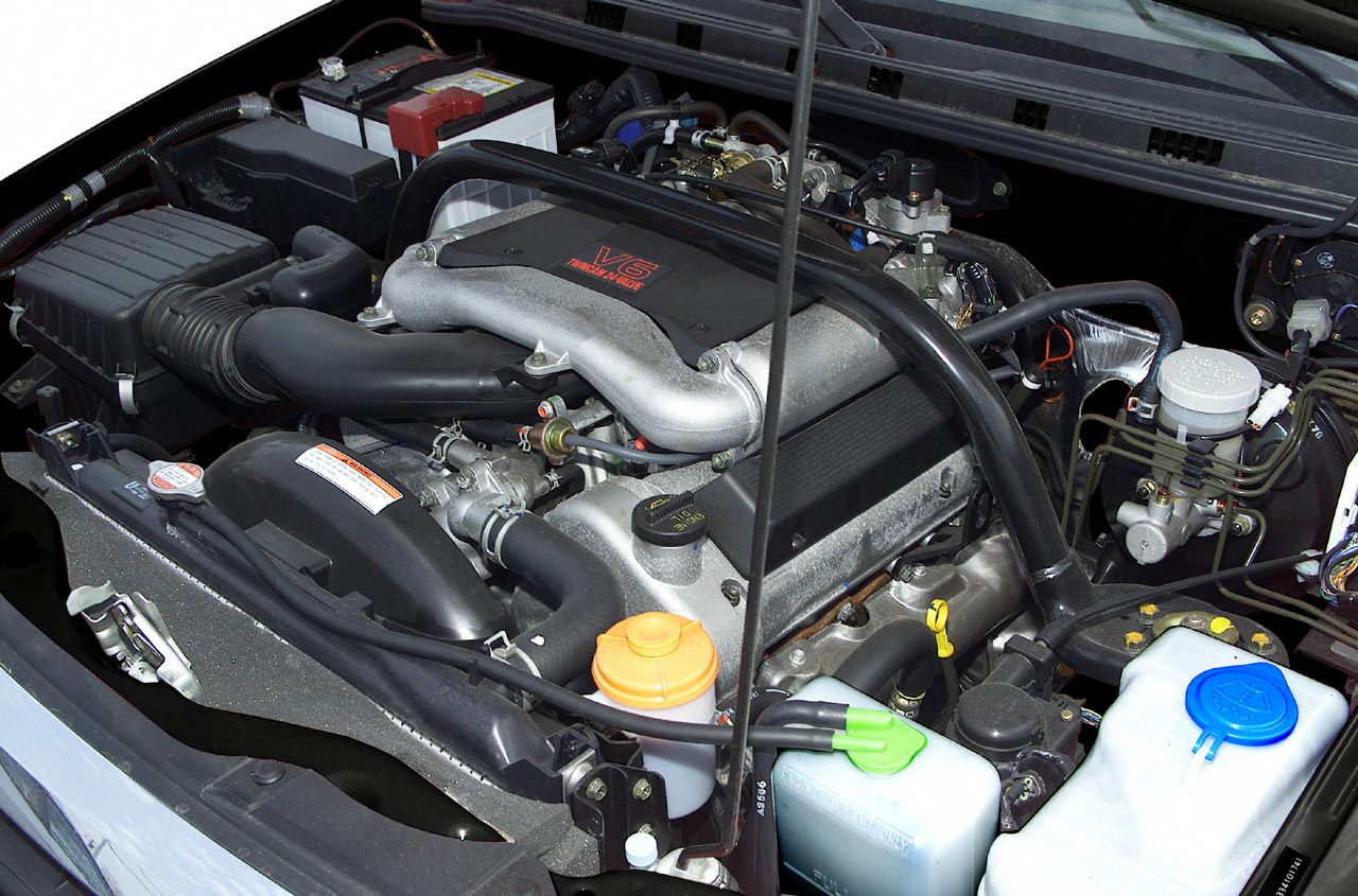 V6 engine layout with air intake and fluid reservoirs