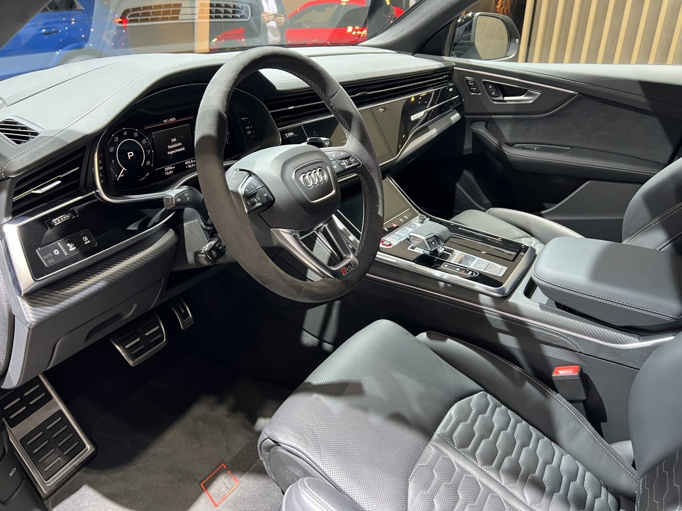 Luxury SUV interior with digital displays and Alcantara steering wheel