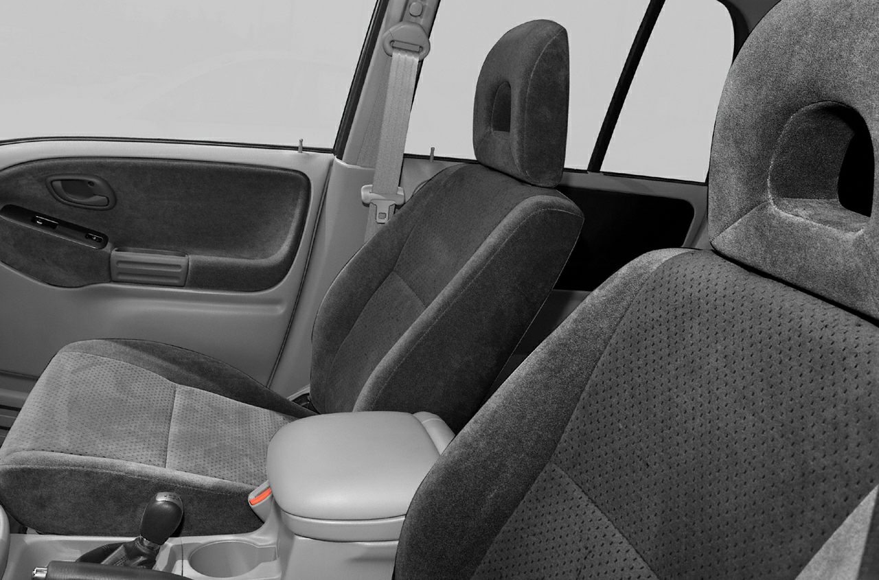 Fabric seats with headrests and center console with gear shift and seatbelt