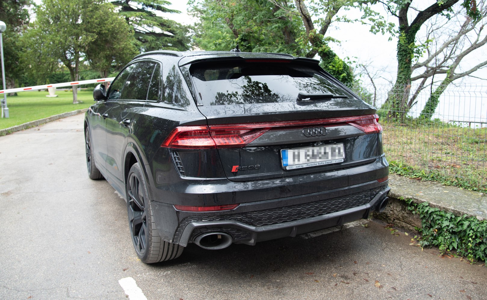 Rear view with LED tail lights and dual exhaust of a performance SUV