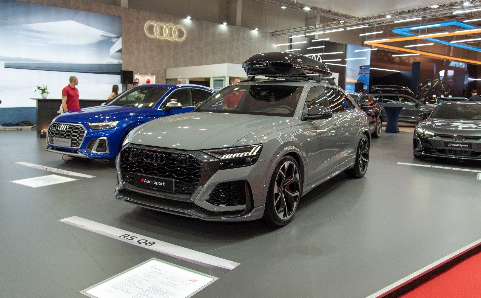 Luxury SUV with roof cargo box and sporty design at auto show