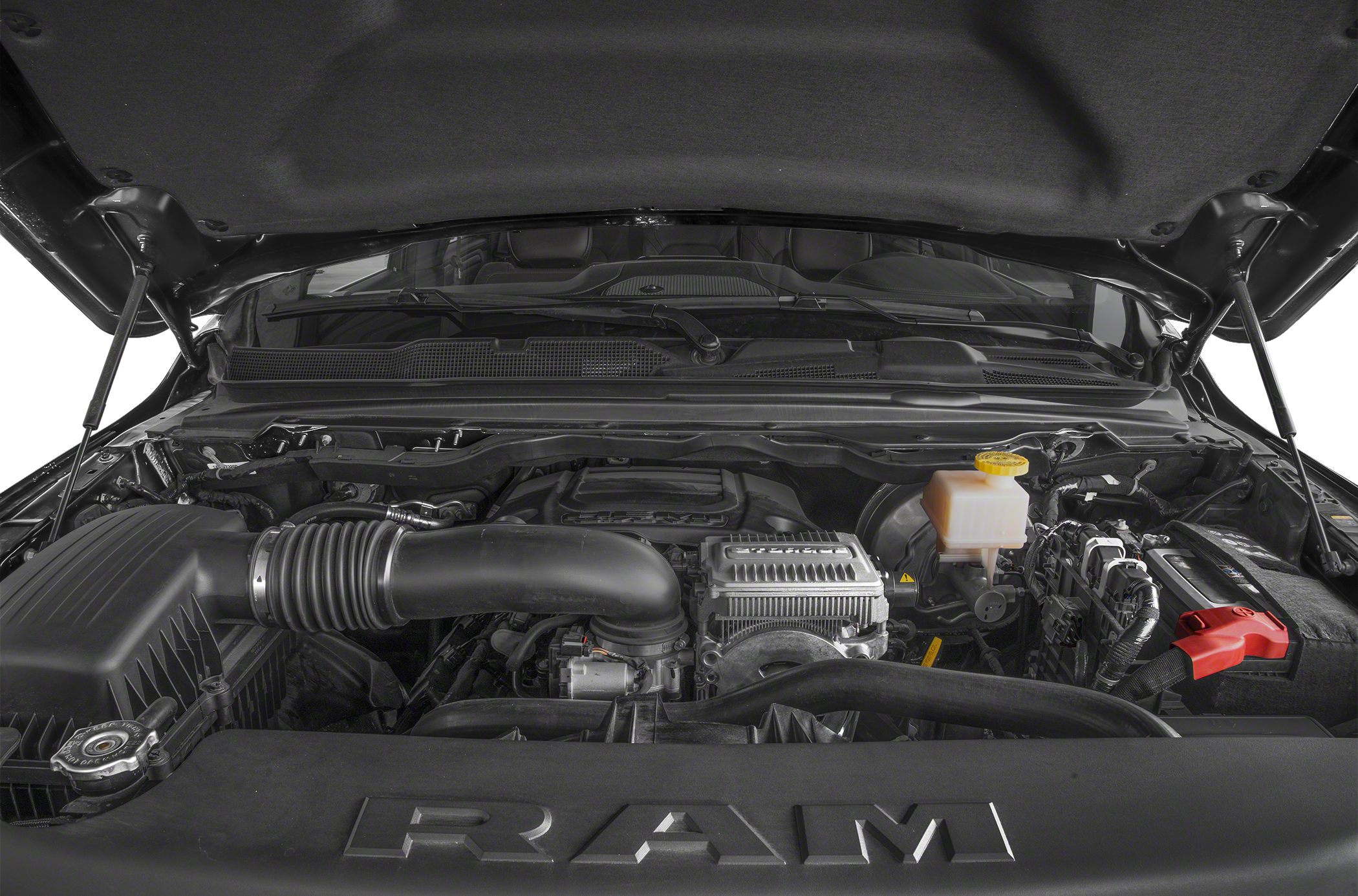 Engine bay with air intake and fluid reservoir