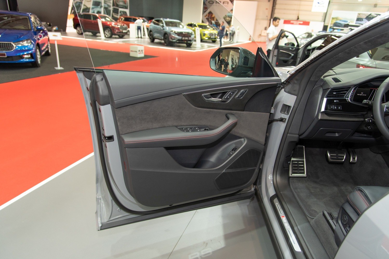 Driver's door panel with controls, premium materials, and partial dashboard view