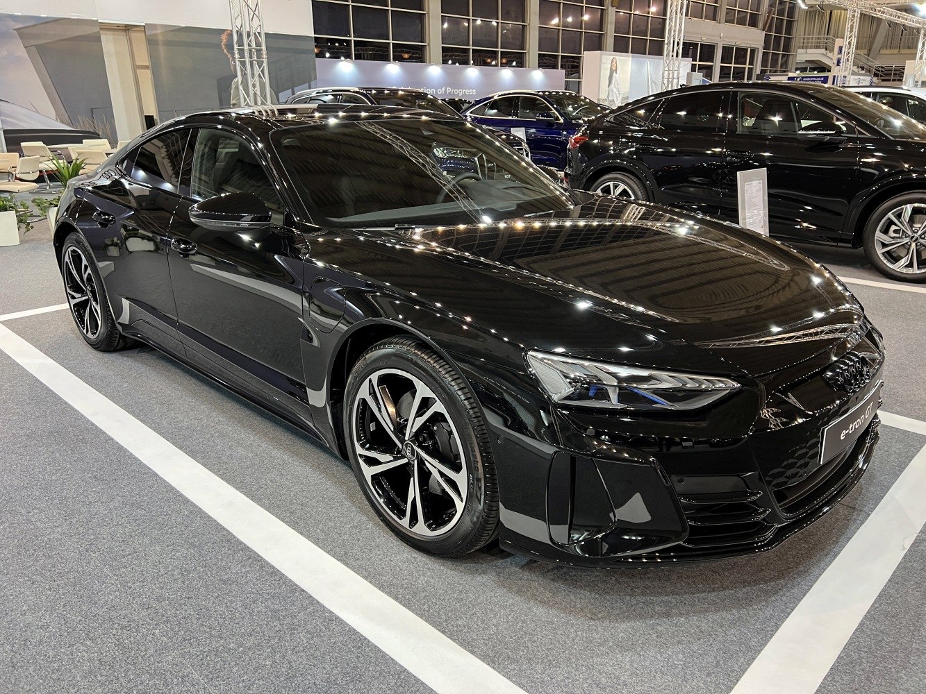 Sleek electric sedan with sharp LED headlights and multi-spoke alloy wheels