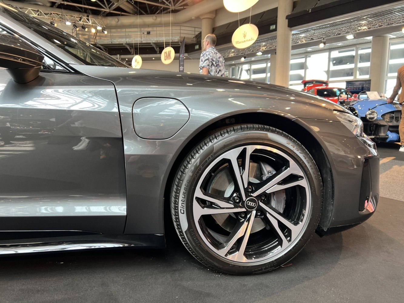 Close-up of alloy wheel and front fender with EV charging port