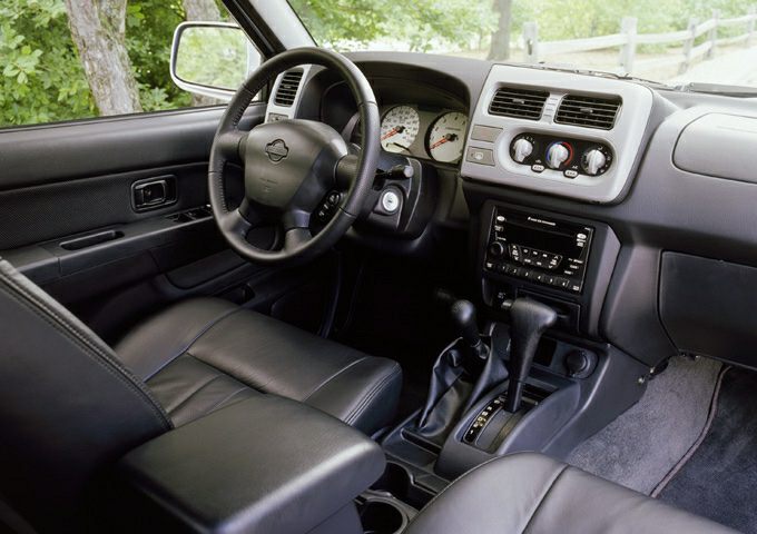 Dashboard, steering wheel, gear shift, and climate controls interior view