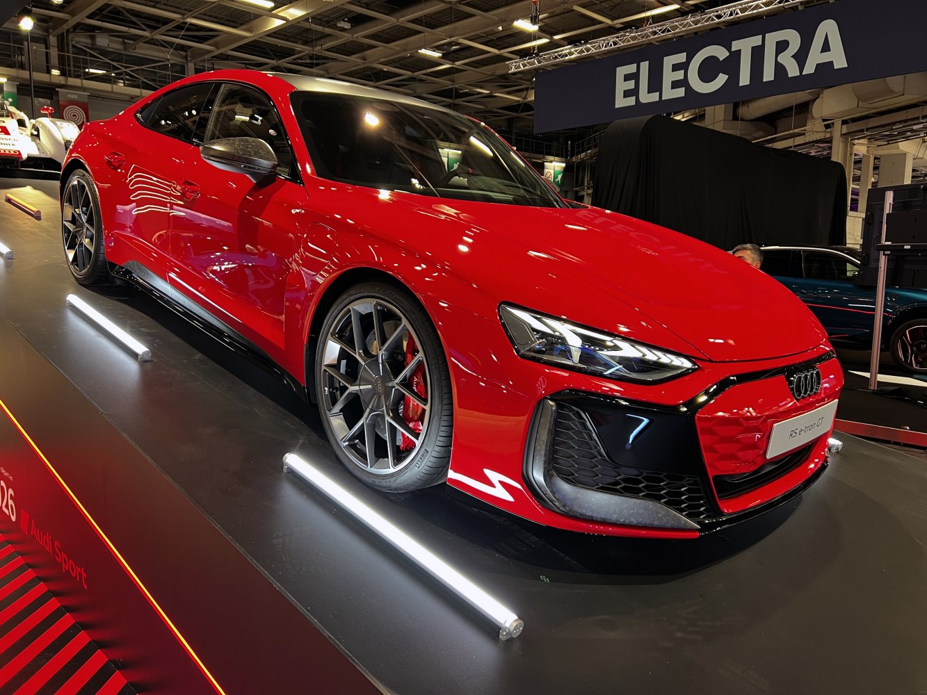 Aggressive front fascia and multi-spoke alloy wheels of a sporty electric sedan