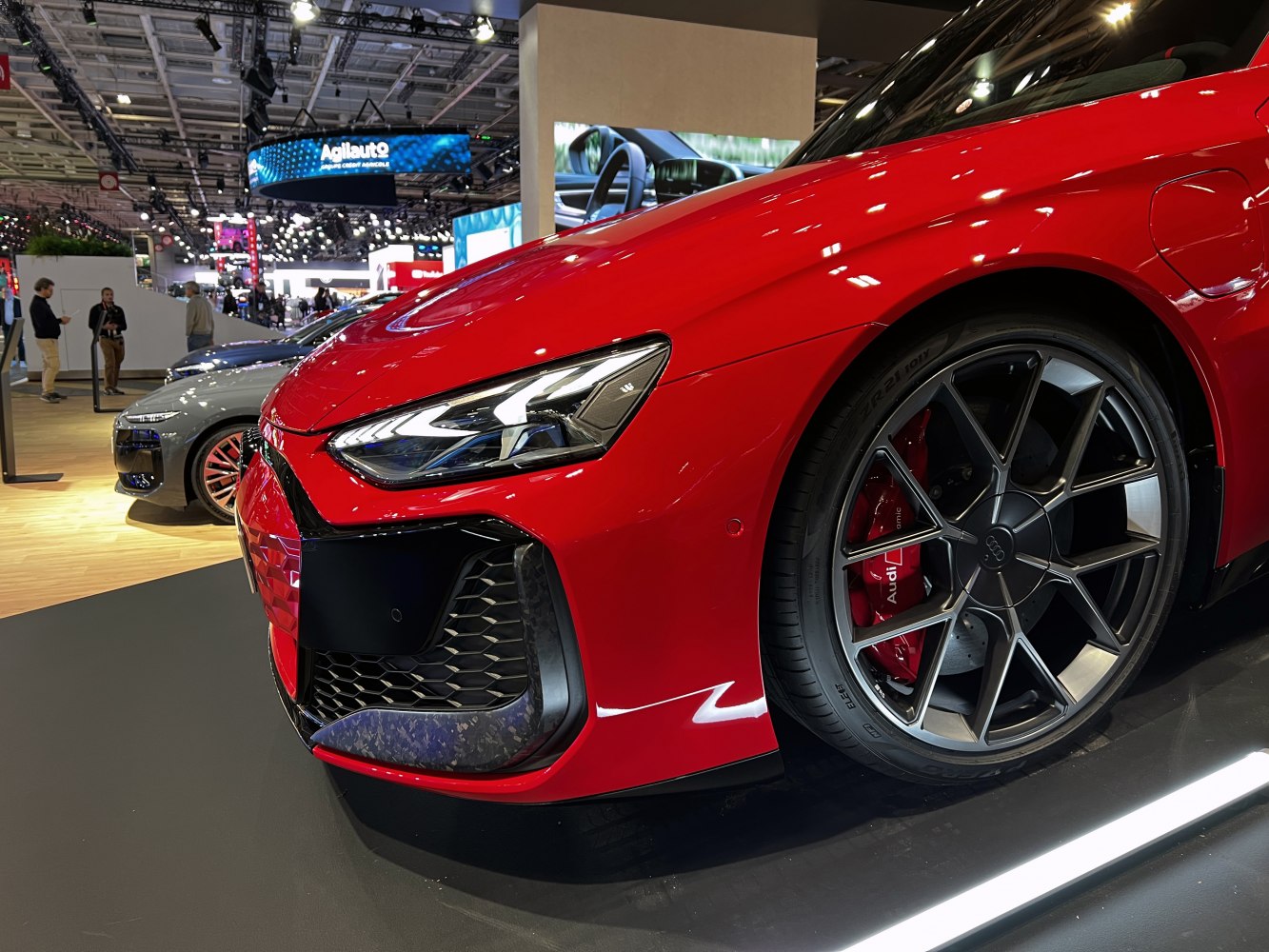 Front headlight and alloy wheel with red brake caliper close-up