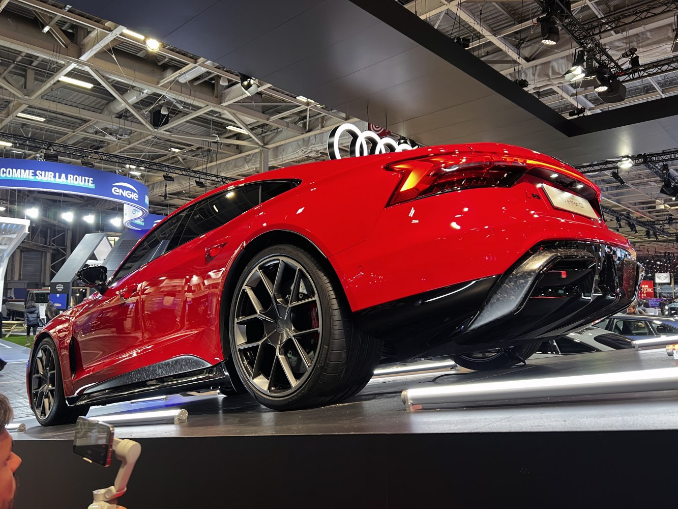 Rear view and alloy wheels of a red electric sedan