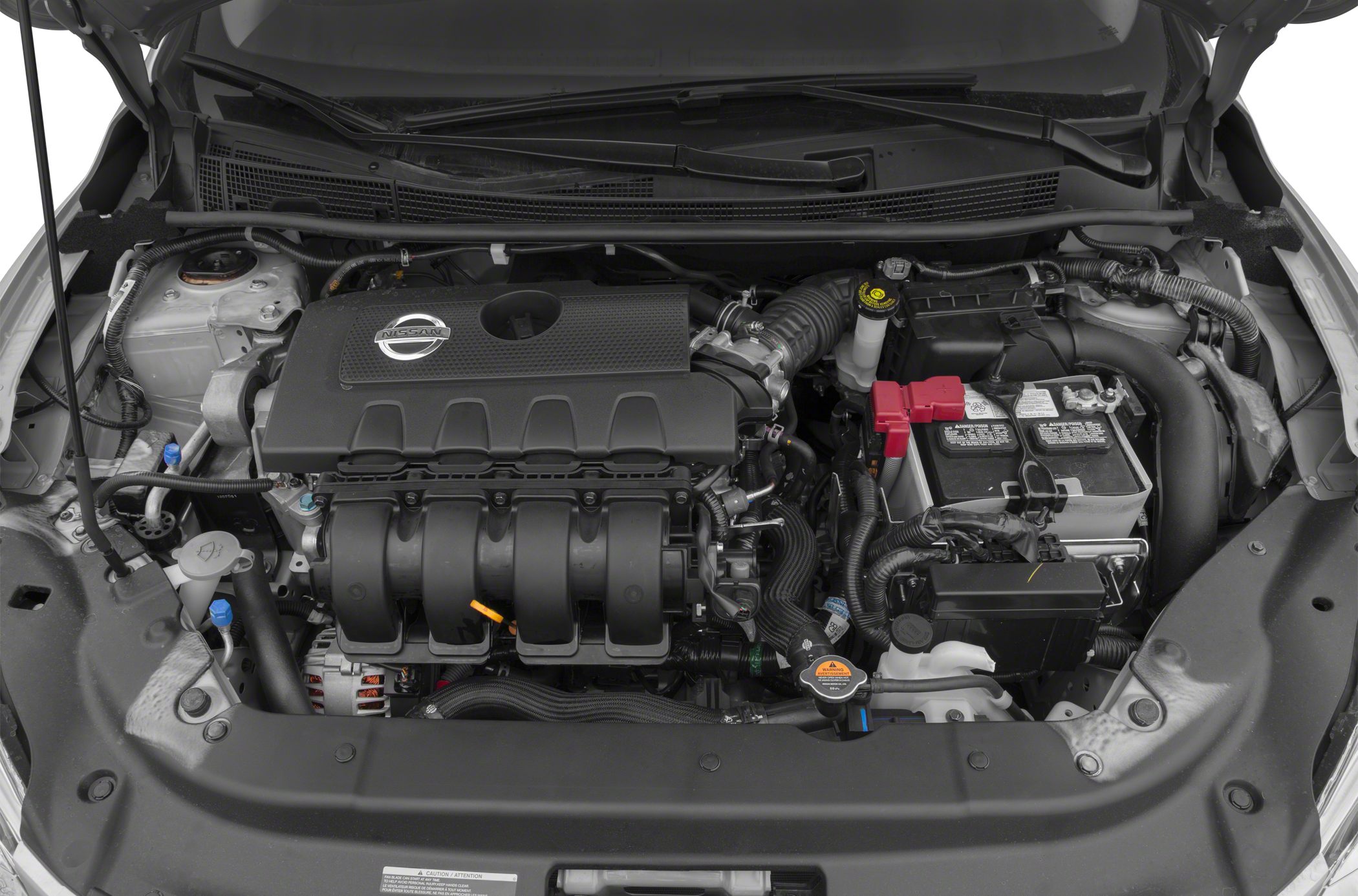 Close-up view of an engine bay with engine cover and battery