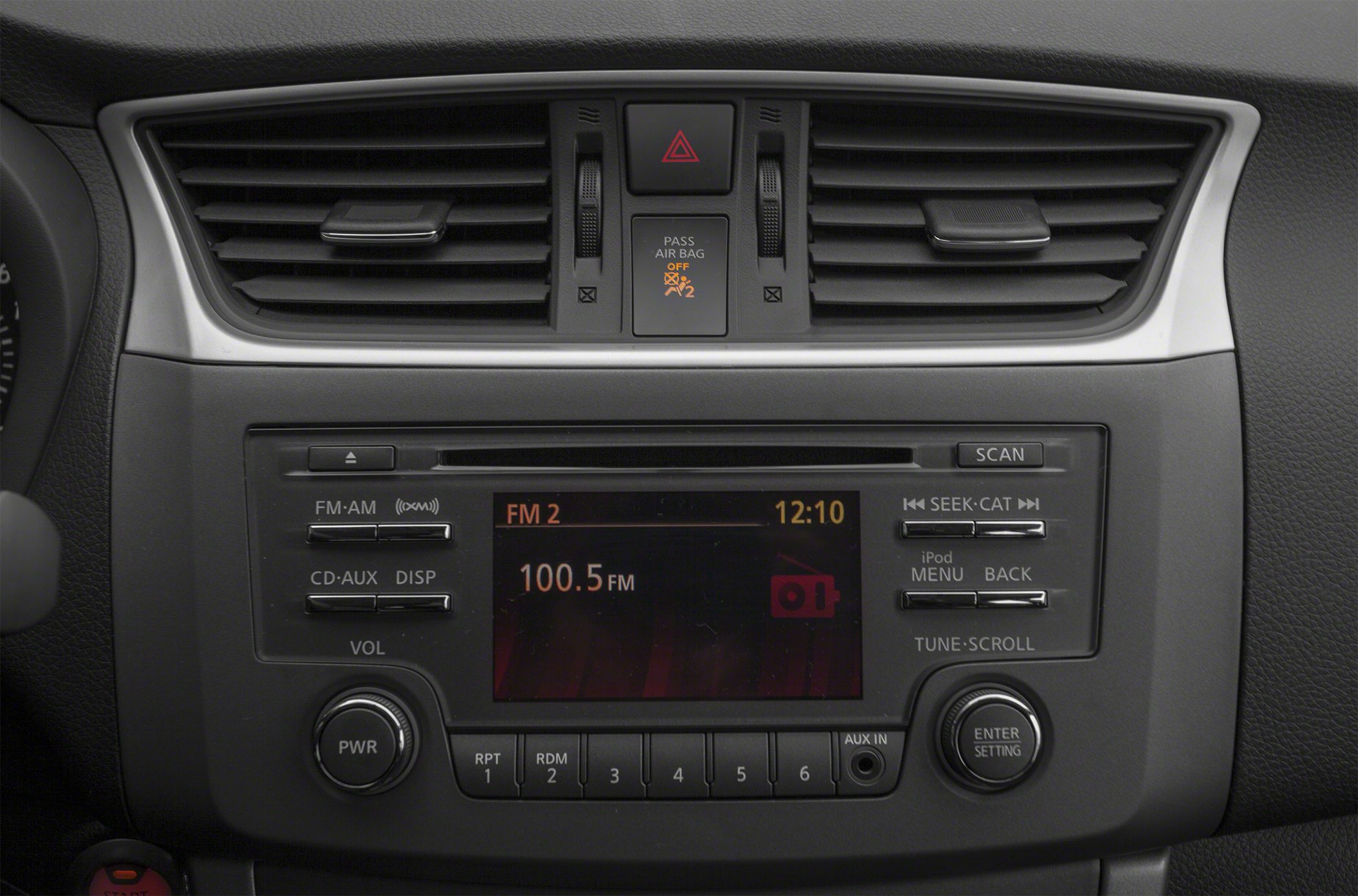 Dashboard radio controls and dual air vents with hazard button