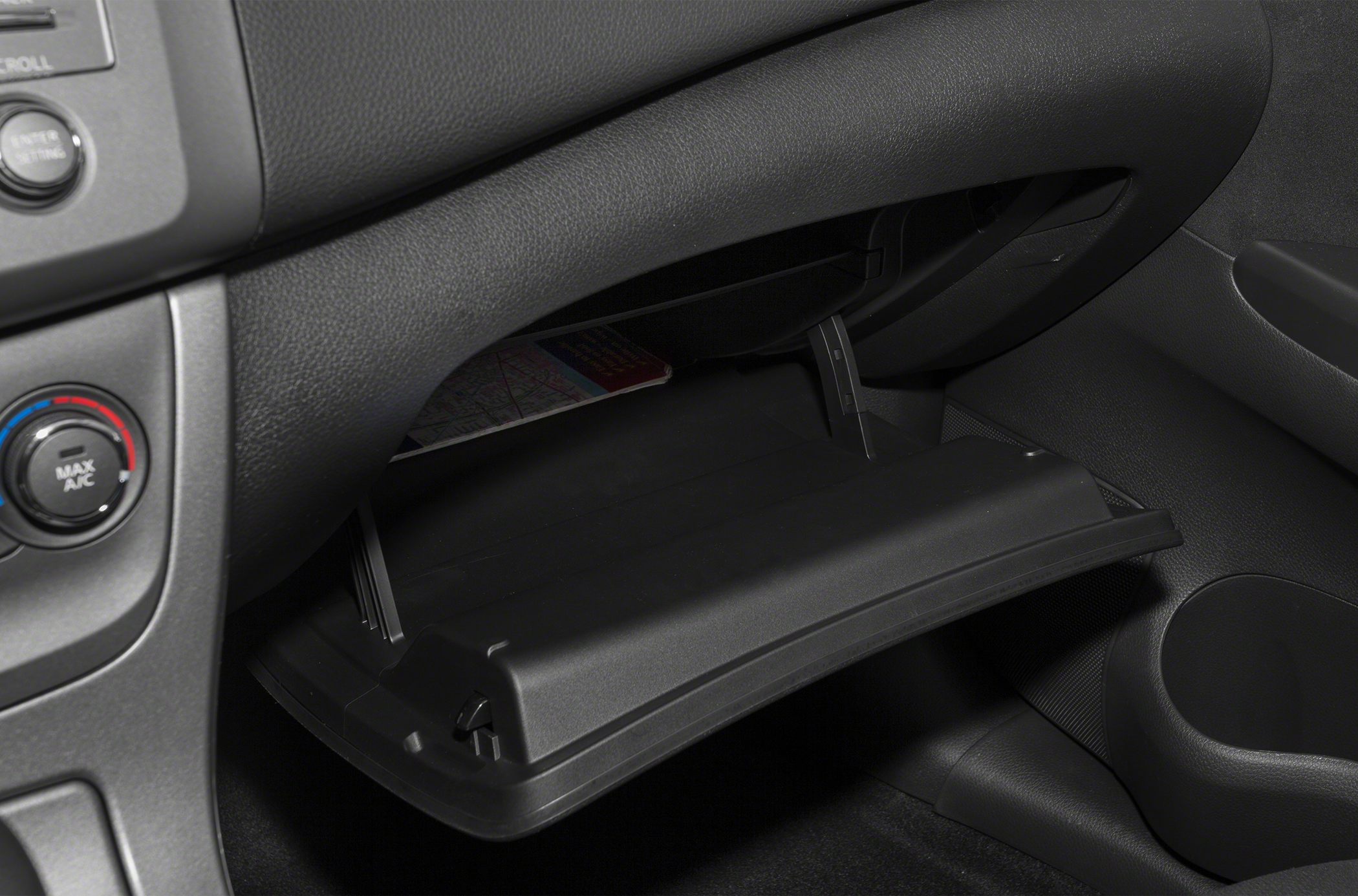 Open glovebox compartment and dashboard interior detail