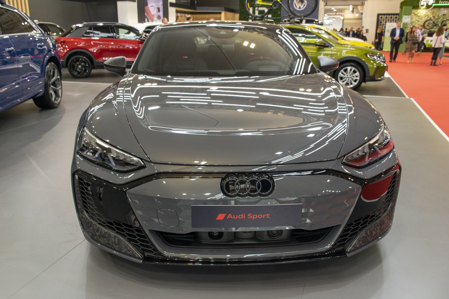 Aggressive LED headlights and sleek front grille of electric sports sedan
