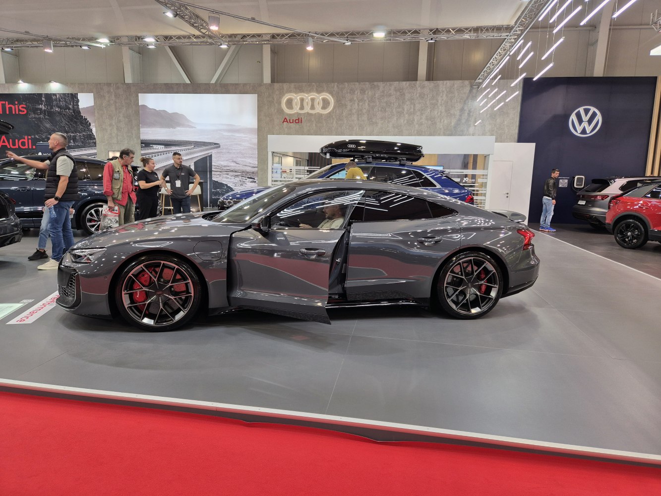 Sporty sedan side profile with open door and red brake calipers