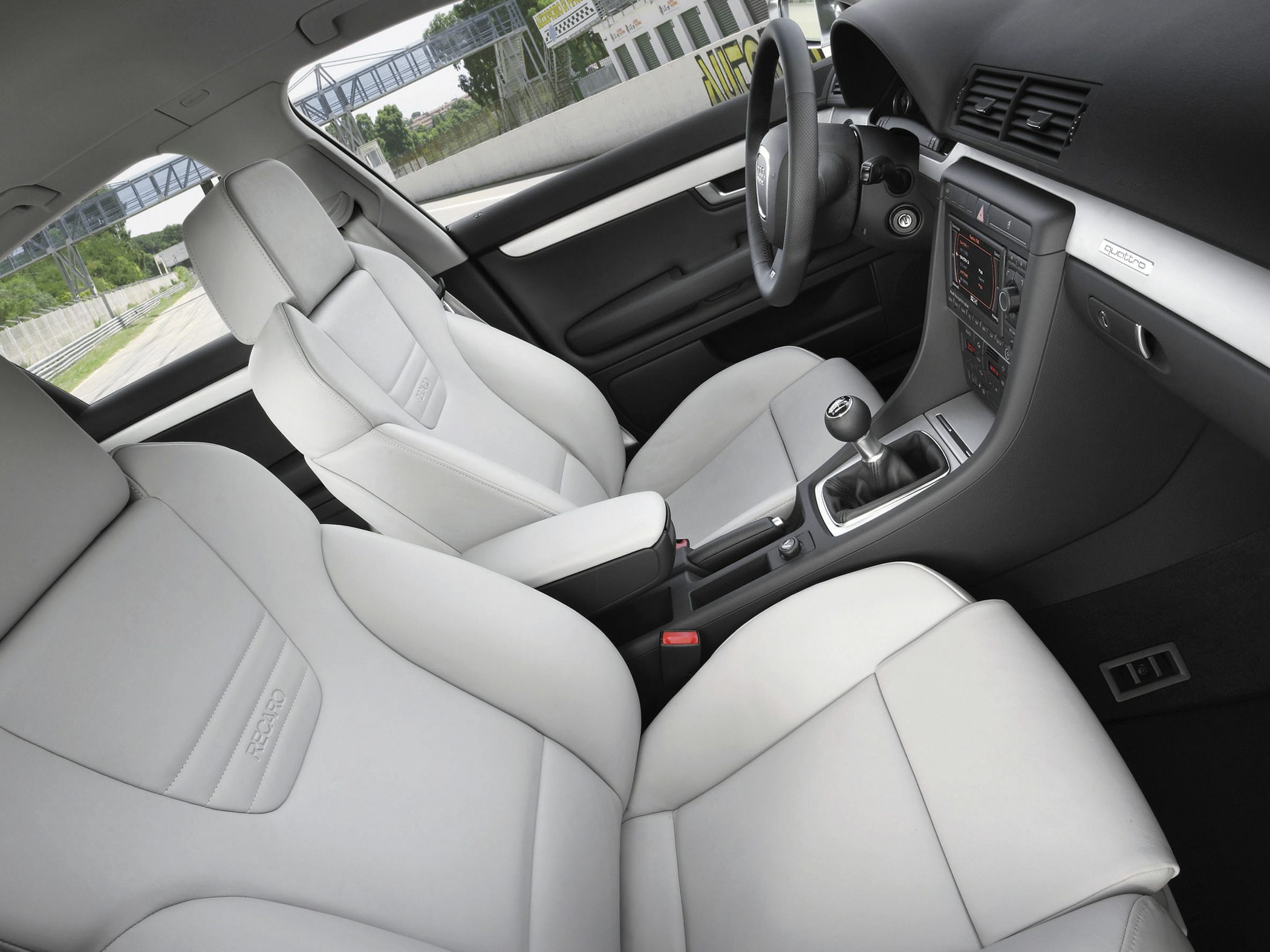 Sporty Recaro seats and manual transmission inside a car cabin