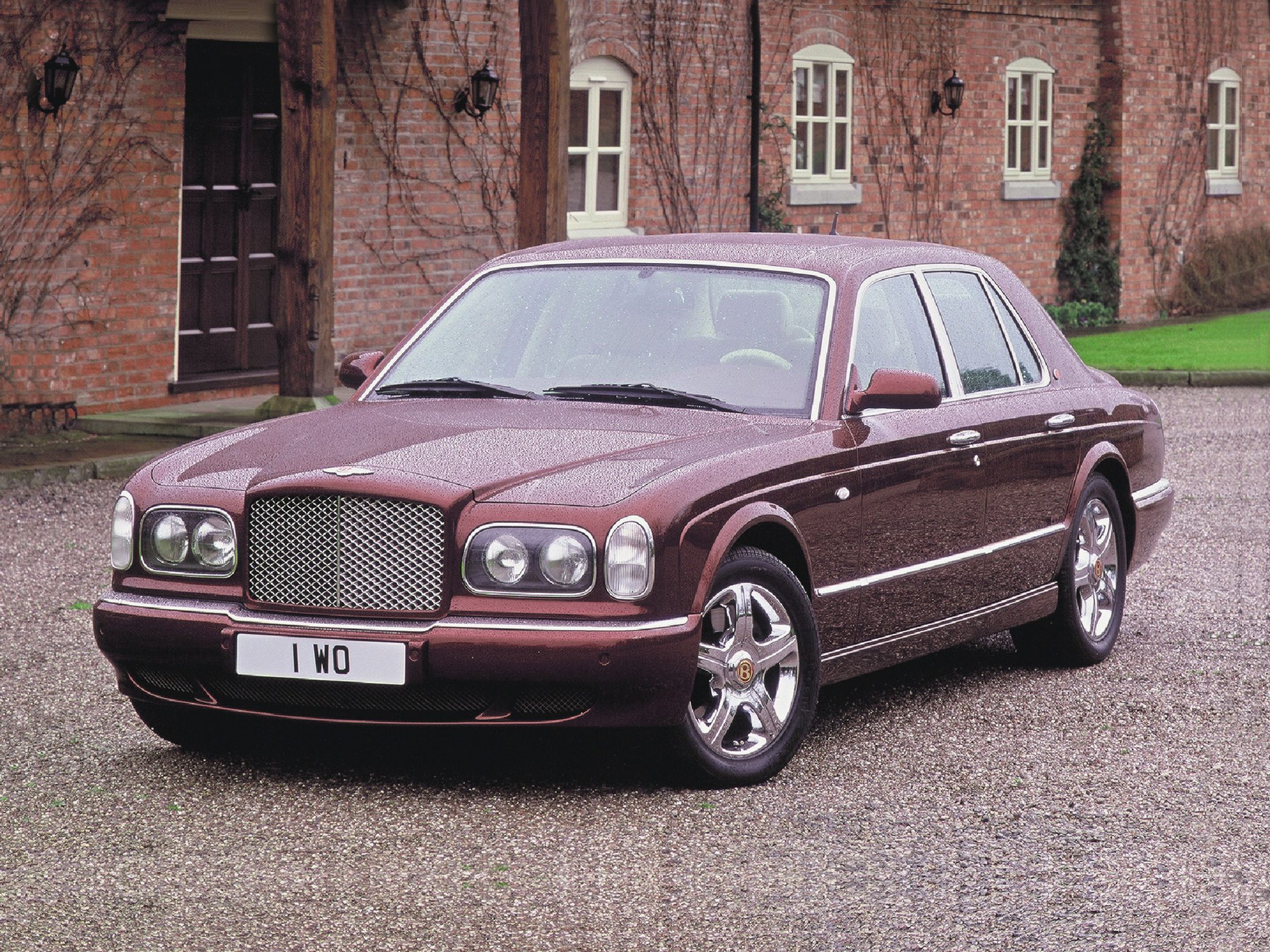 Luxury sedan with distinctive headlight design and chrome mesh grille