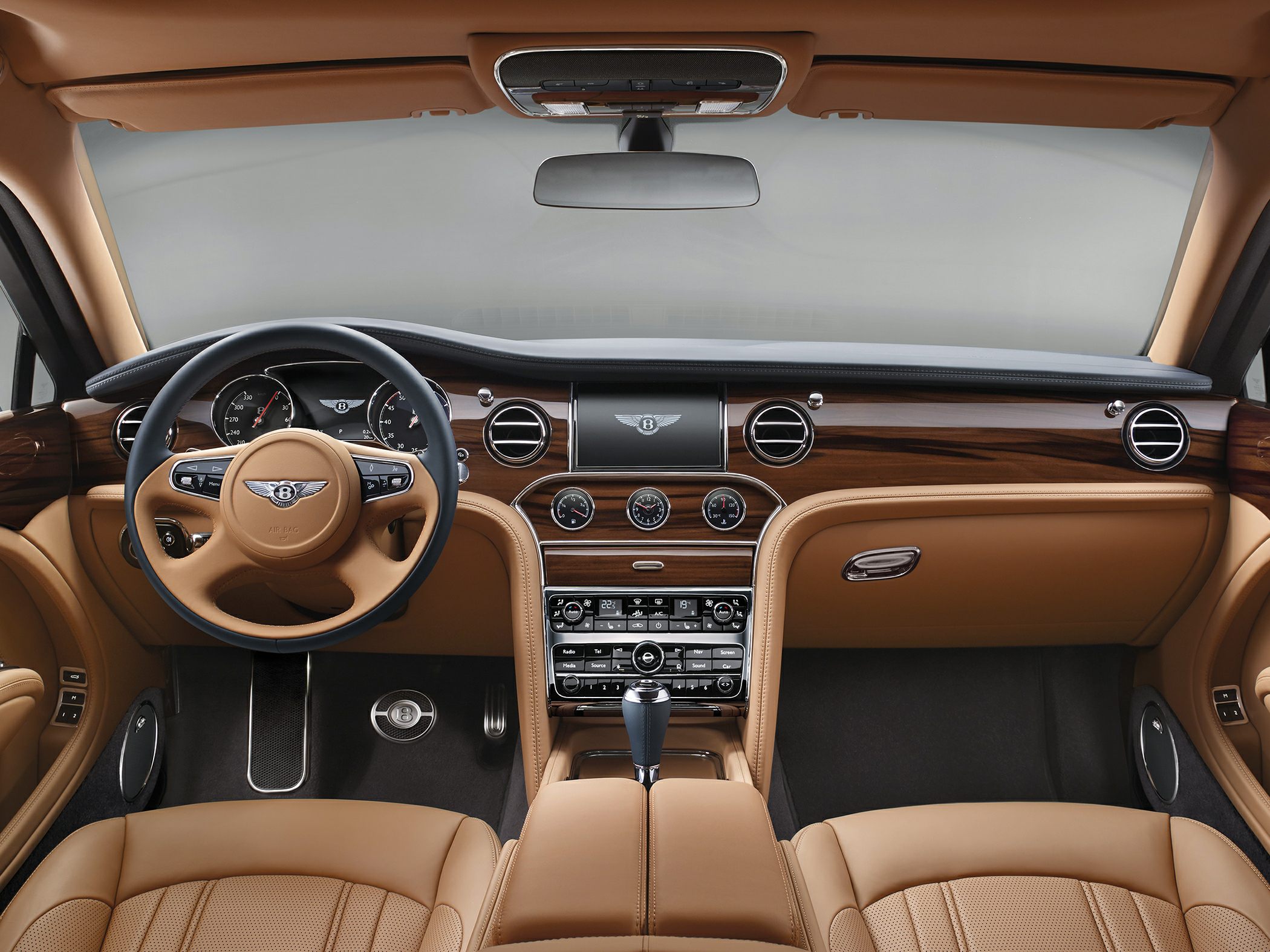 Luxury leather interior dashboard with wood trim and analog clock