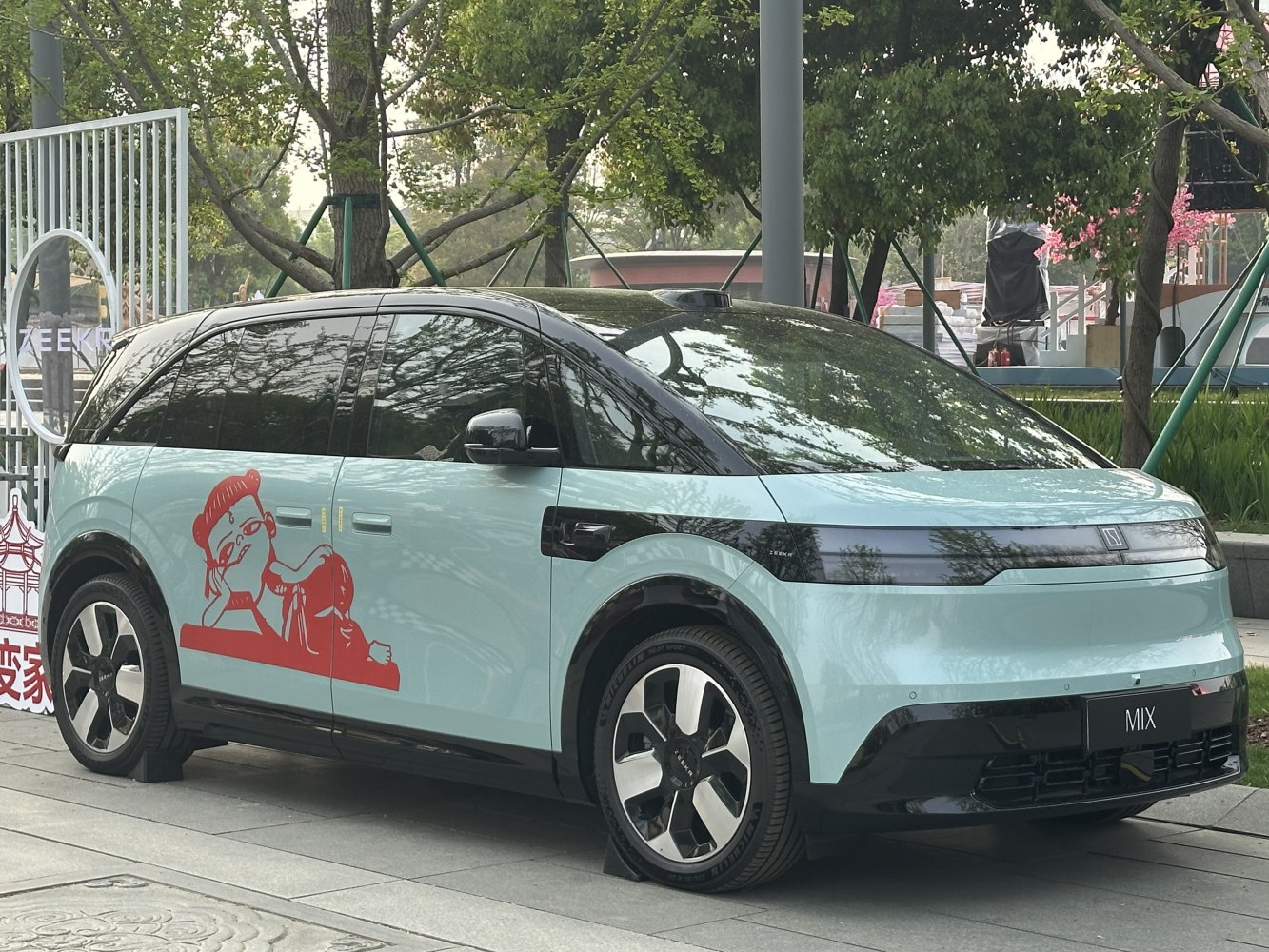 Sleek electric SUV with tinted windows and red side artwork