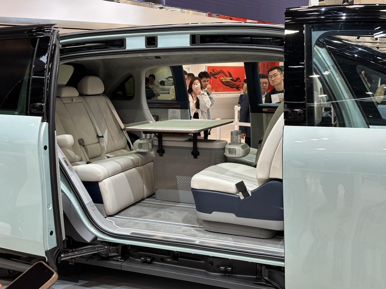Spacious car interior with leather seating and folding table