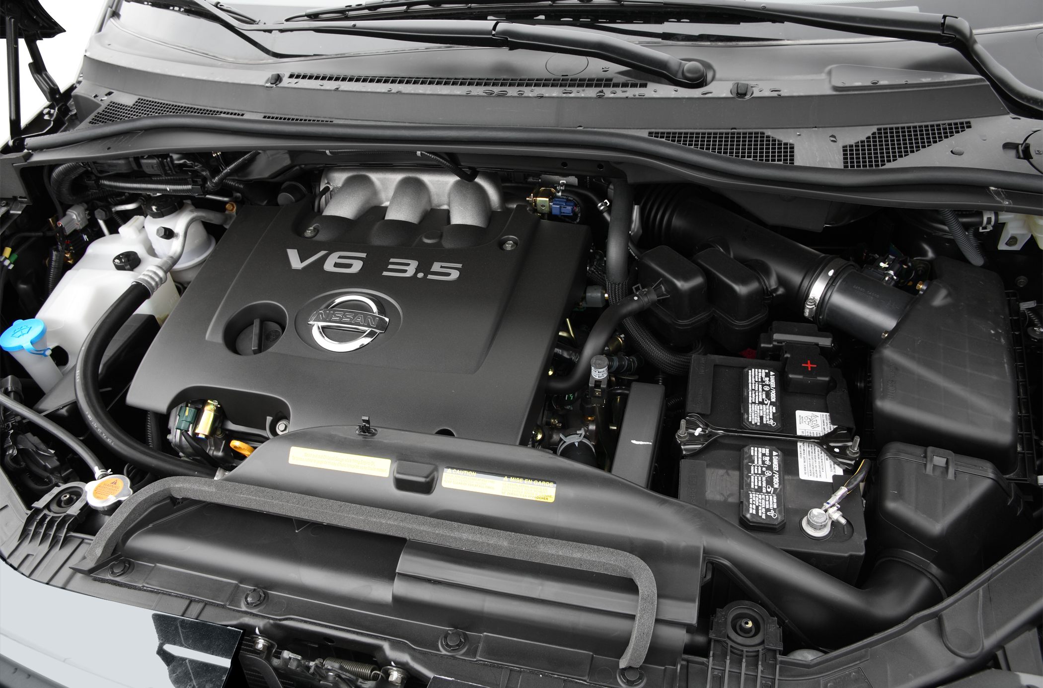 Nissan V6 3.5L engine bay with battery and air intake system