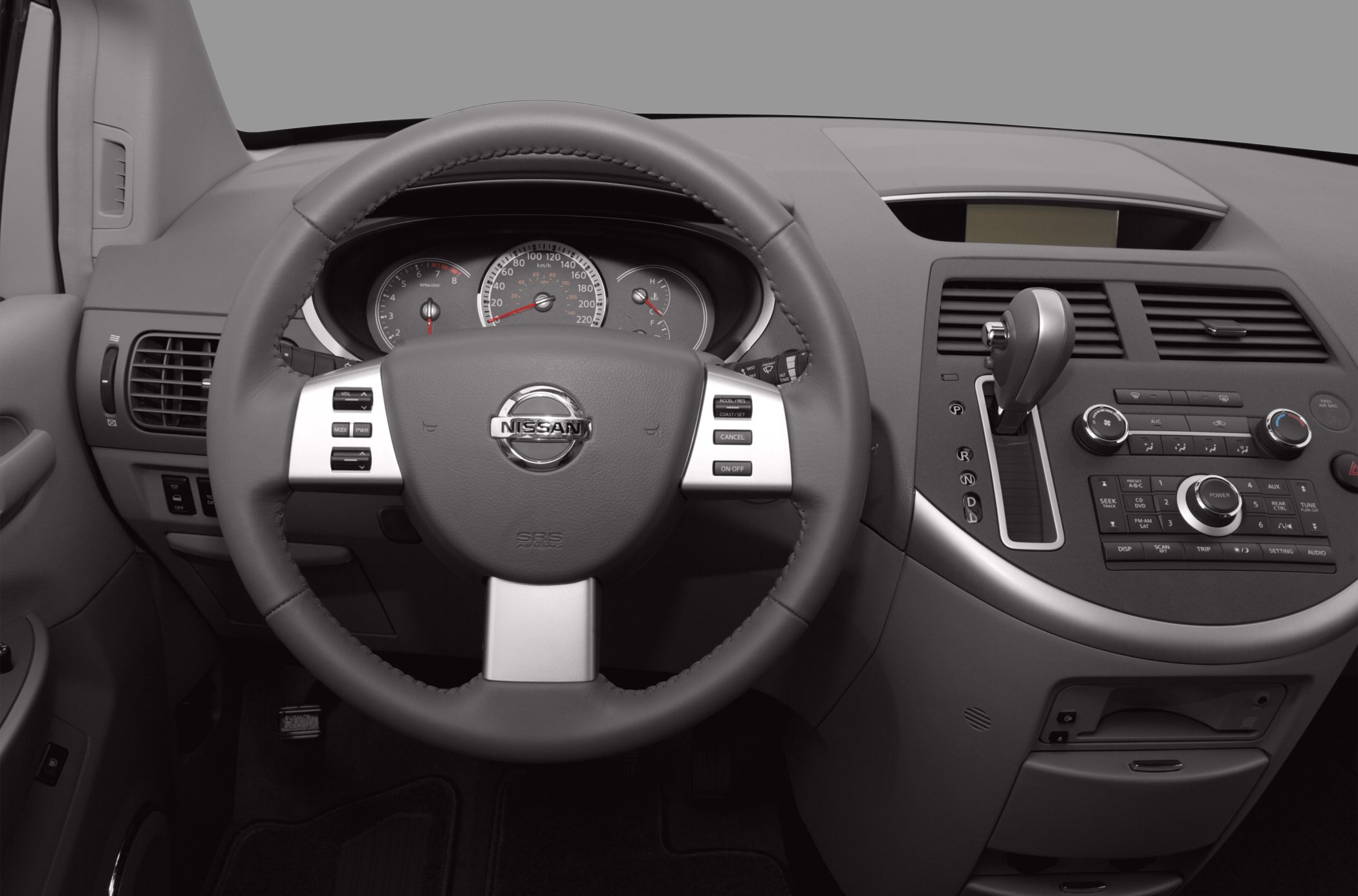 Steering wheel with controls and center console with gear shifter and radio unit