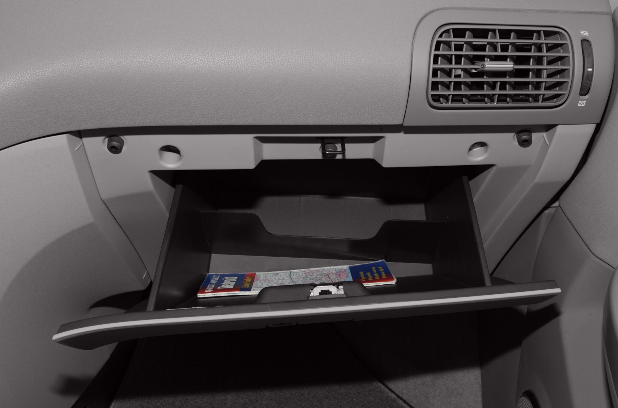 Open glove compartment with interior storage and map inside