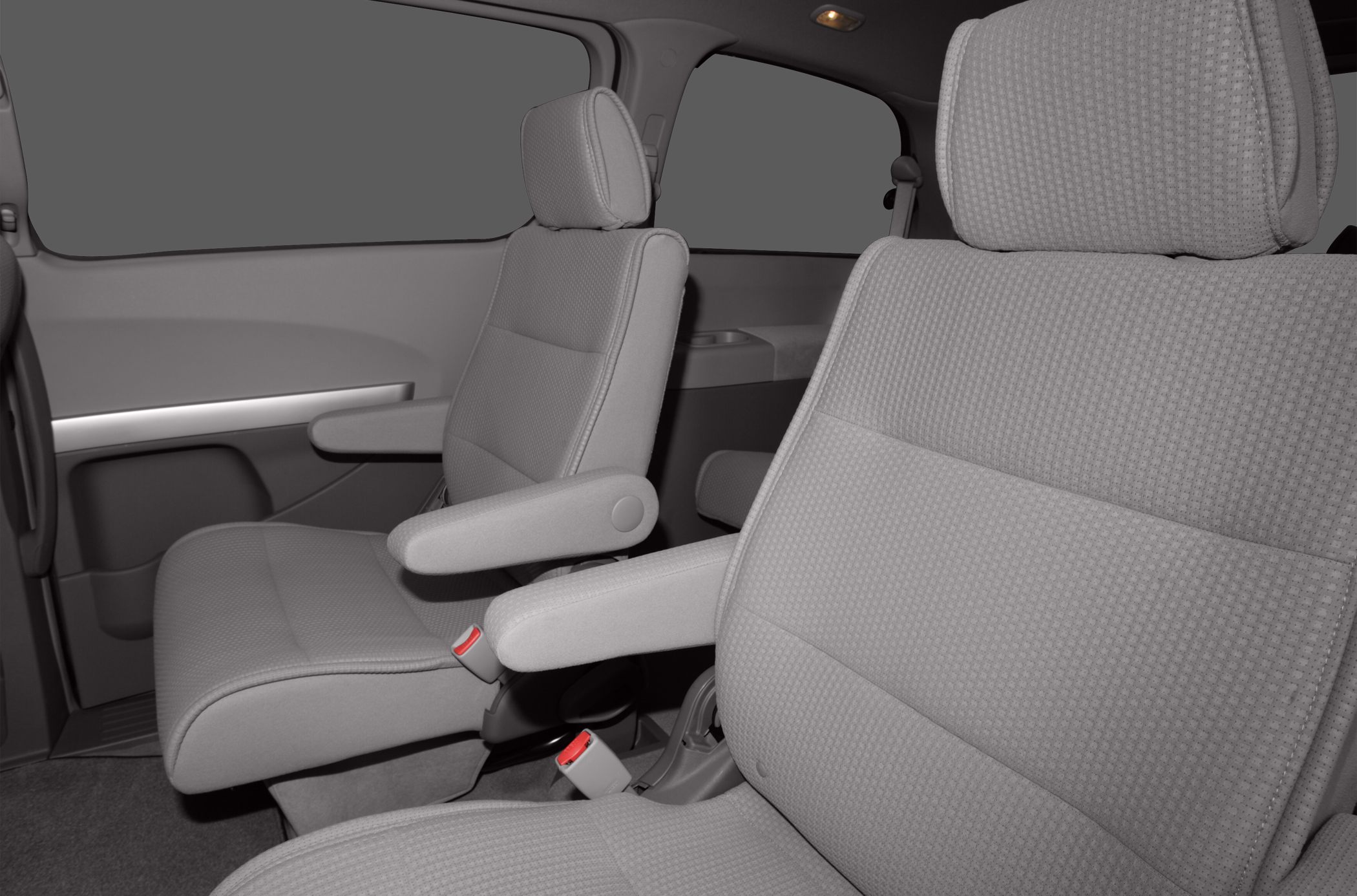 Fabric second-row seats with armrests inside a minivan