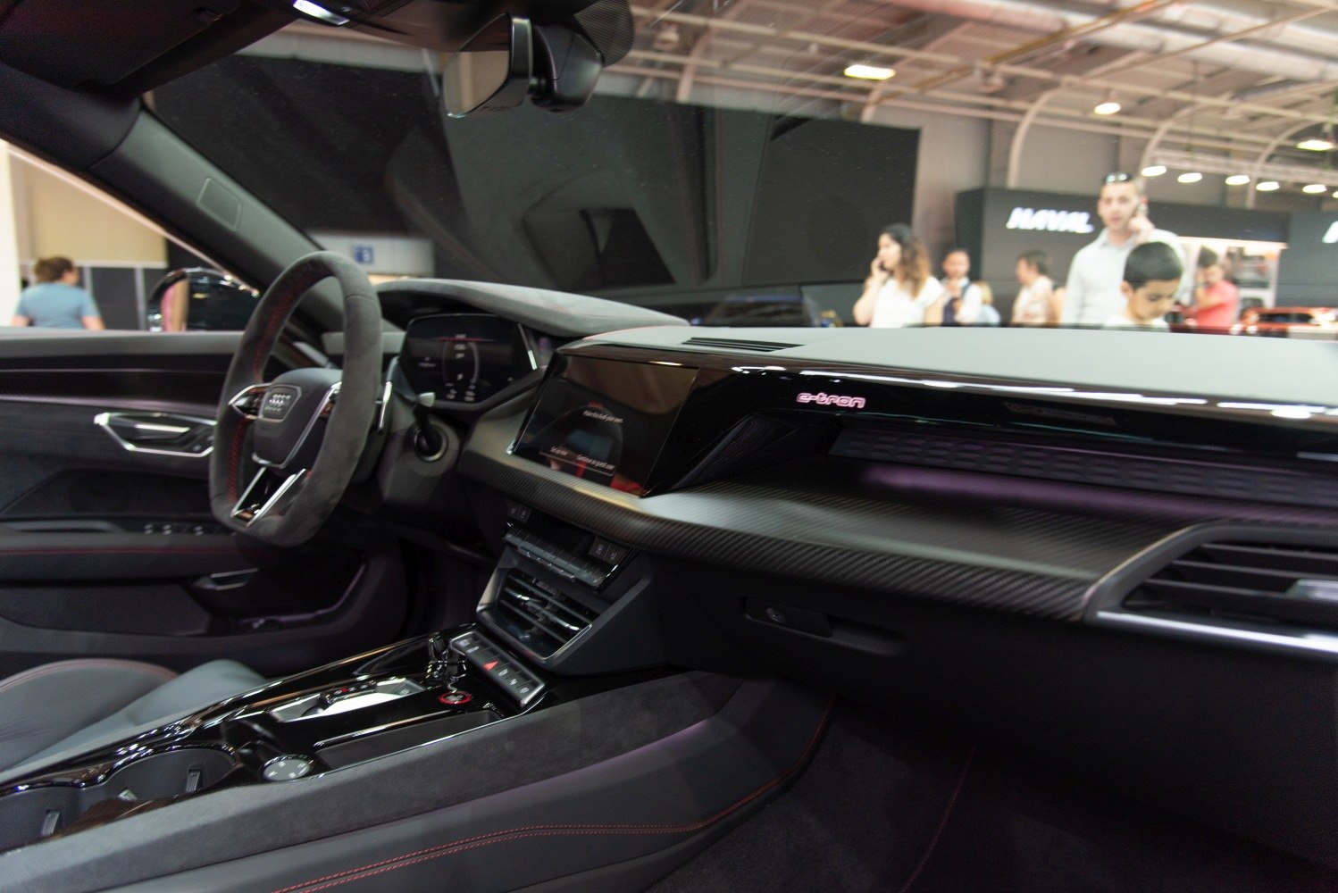 Electric car dashboard with digital displays and carbon fiber trim