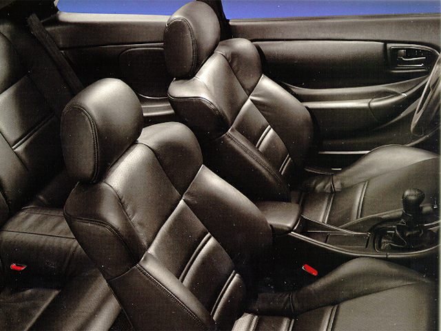 Black leather bucket seats and manual gear shift in car interior