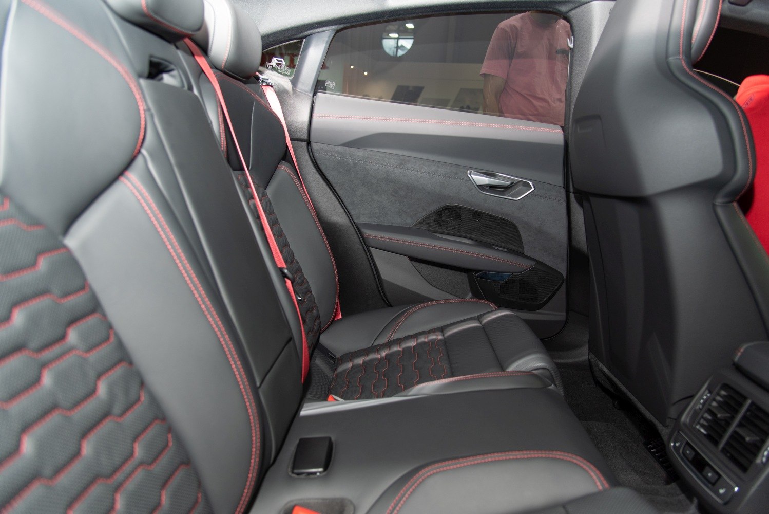 Rear interior with black leather seats and red contrast stitching