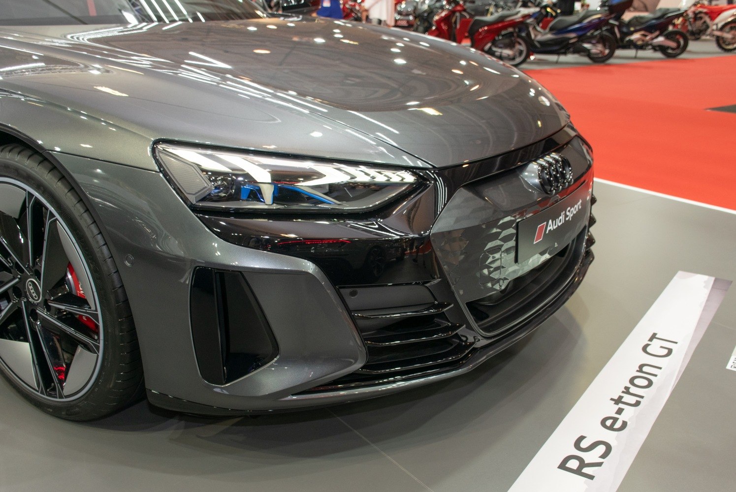 Close-up of front grille, LED headlight, and wheel design.