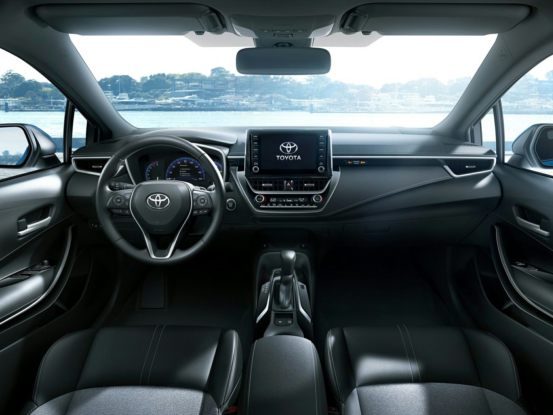 Modern car interior with dashboard, touchscreen, and steering wheel
