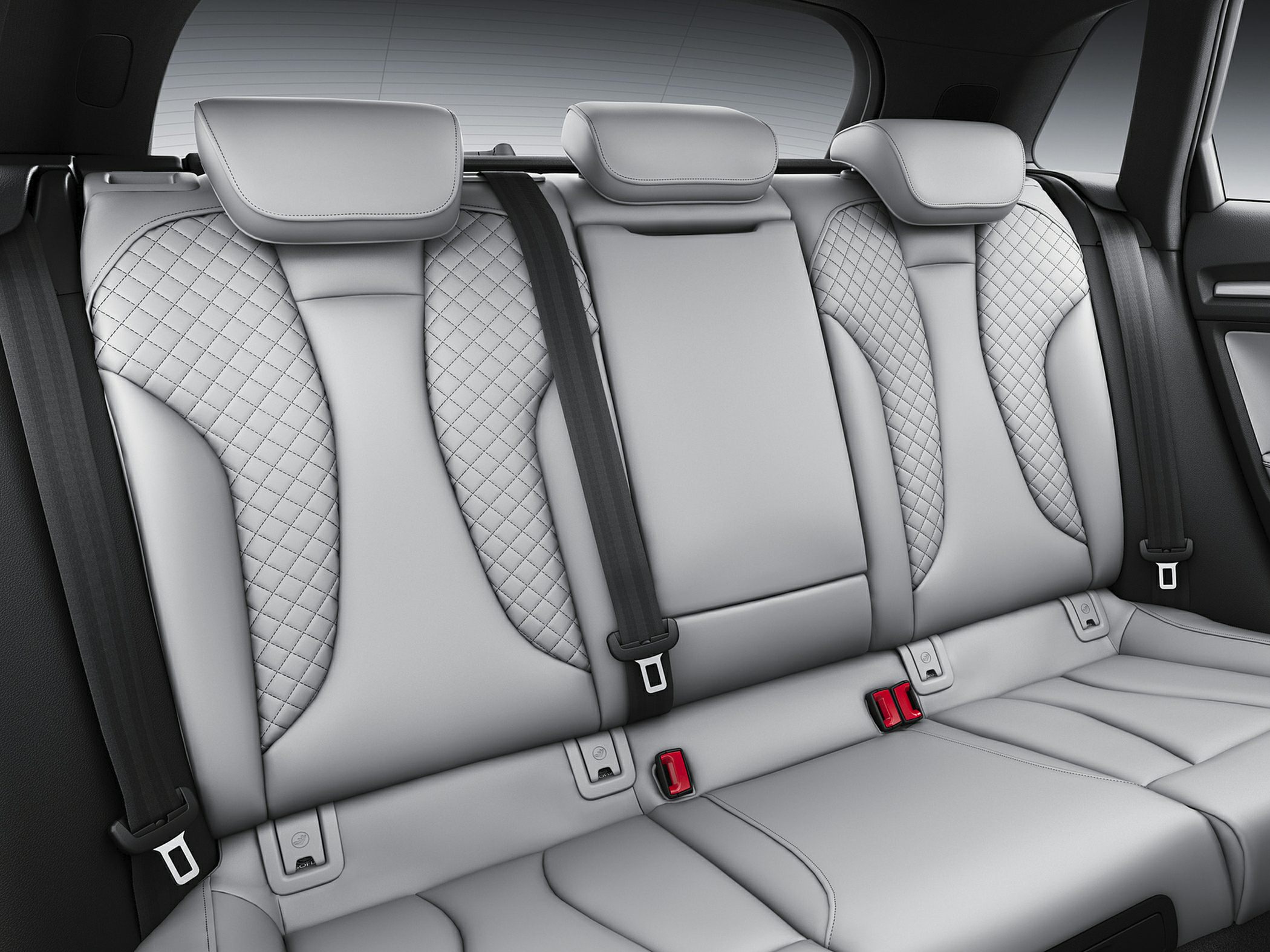 Quilted leather rear seats with three headrests and seatbelts