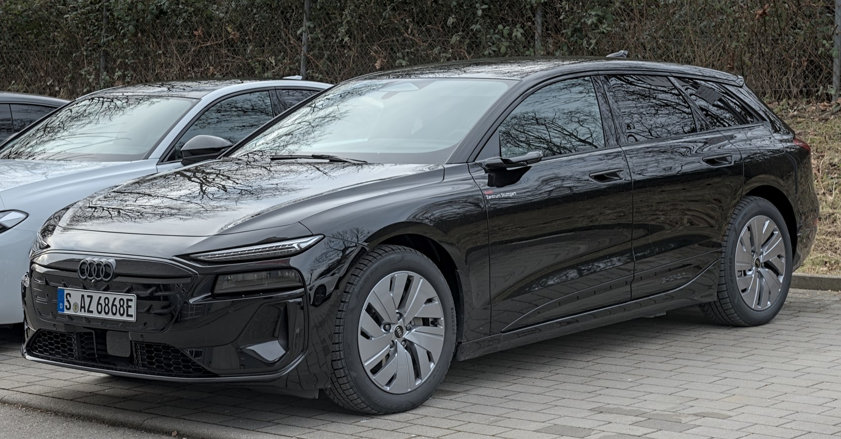Electric touring vehicle with aerodynamic wheels and LED headlights.