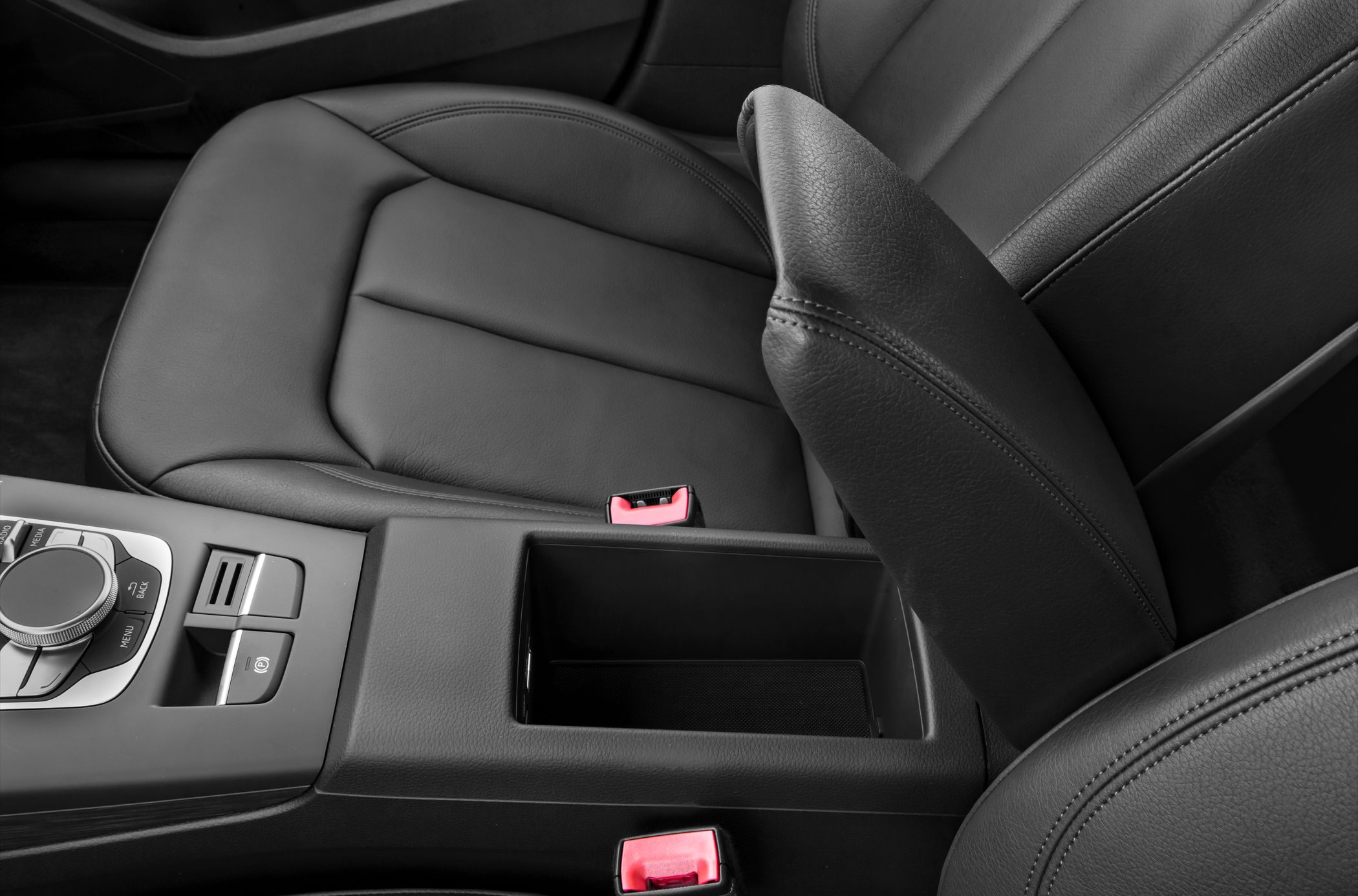Center console with control knob and open armrest storage