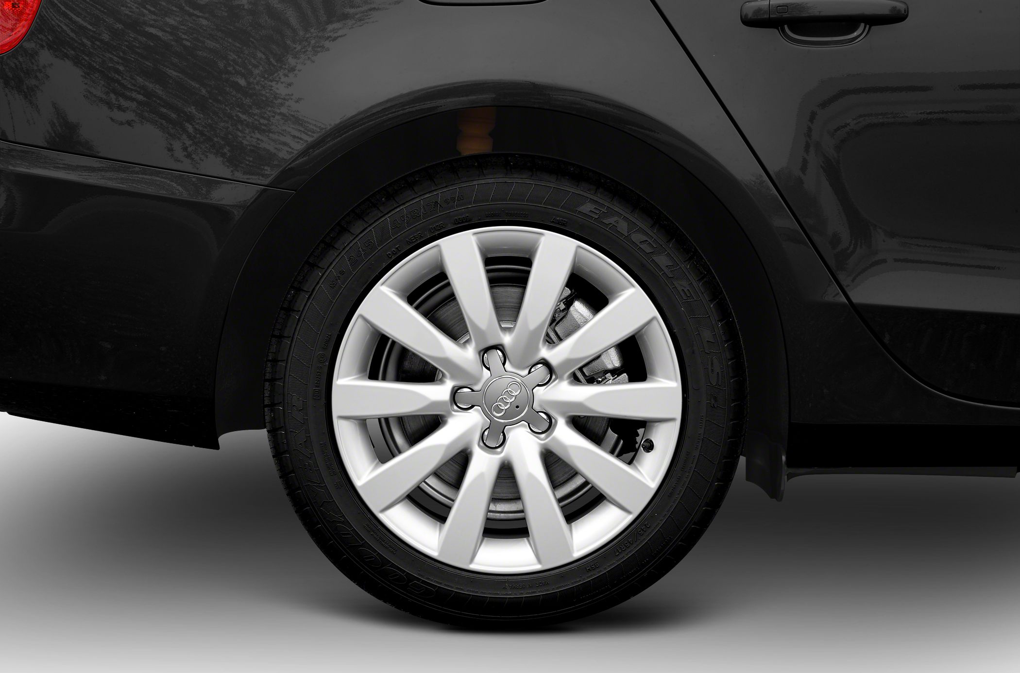 Silver multi-spoke alloy wheel with visible brake disc and caliper