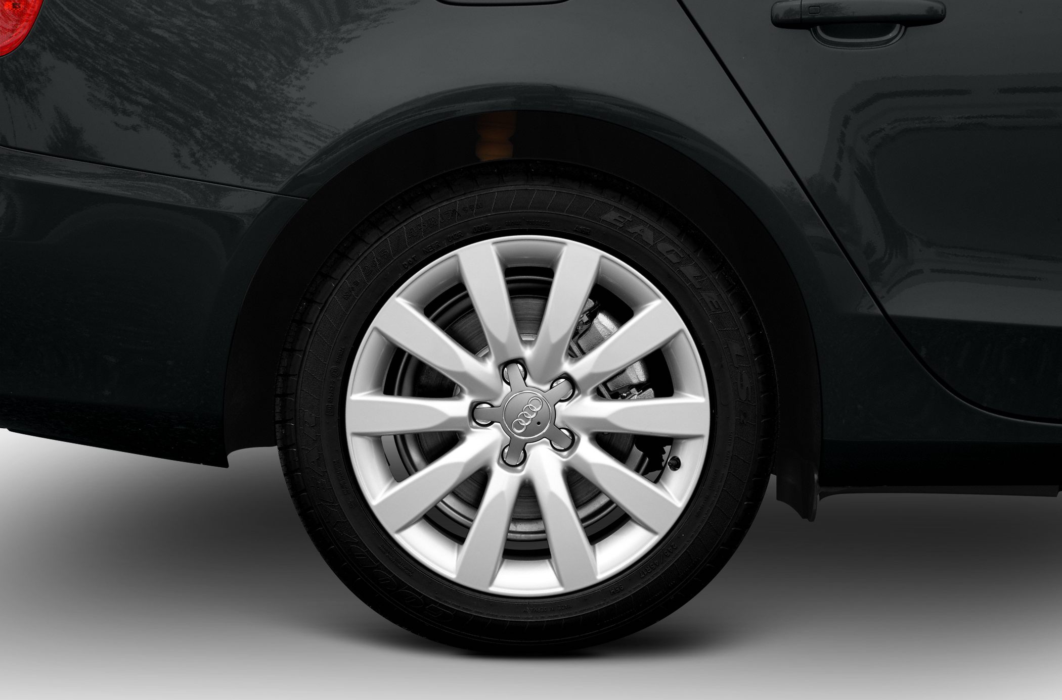 Close-up of silver 10-spoke alloy wheel and tire on rear side of vehicle