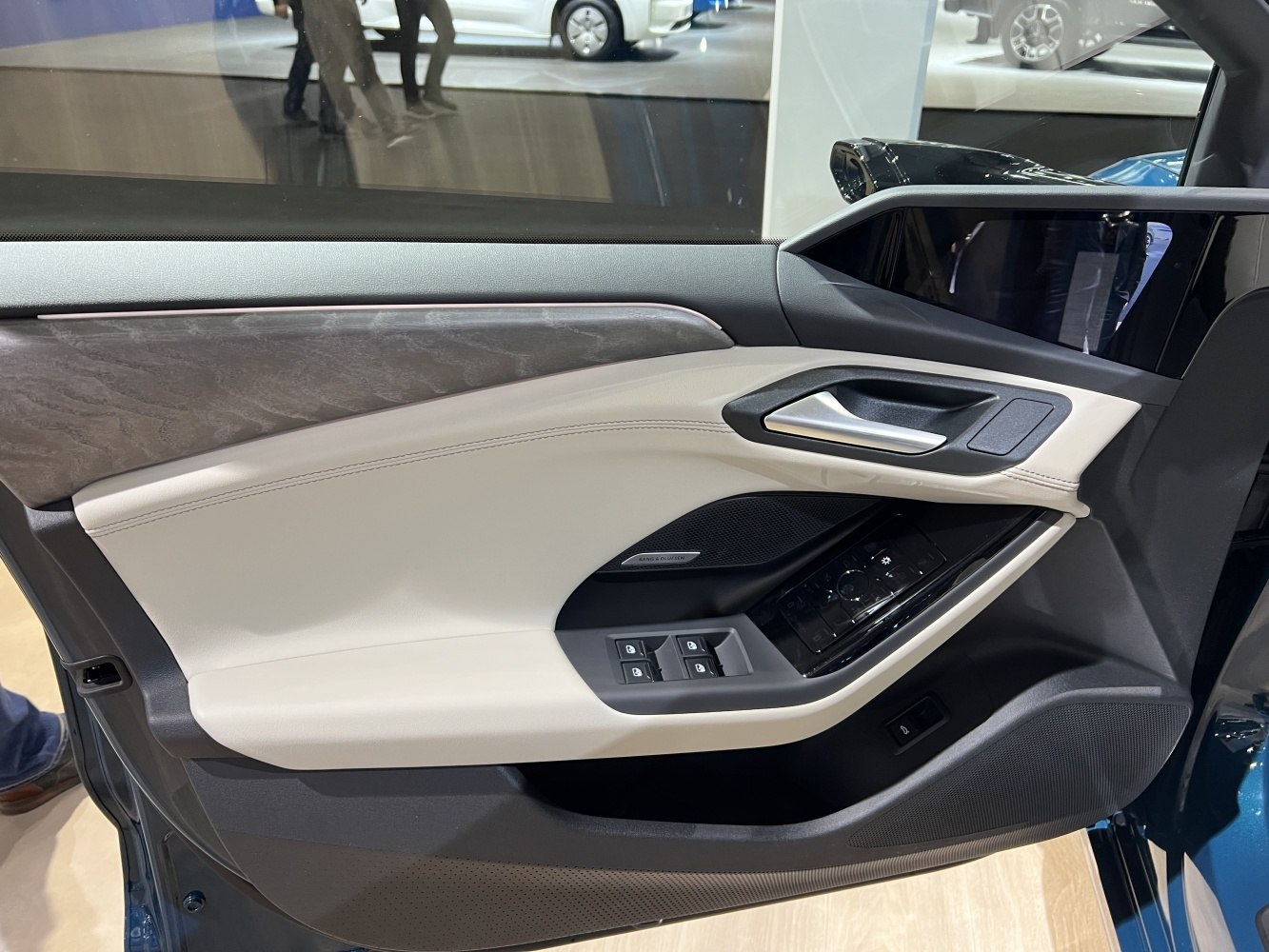 Interior door panel with controls and premium materials