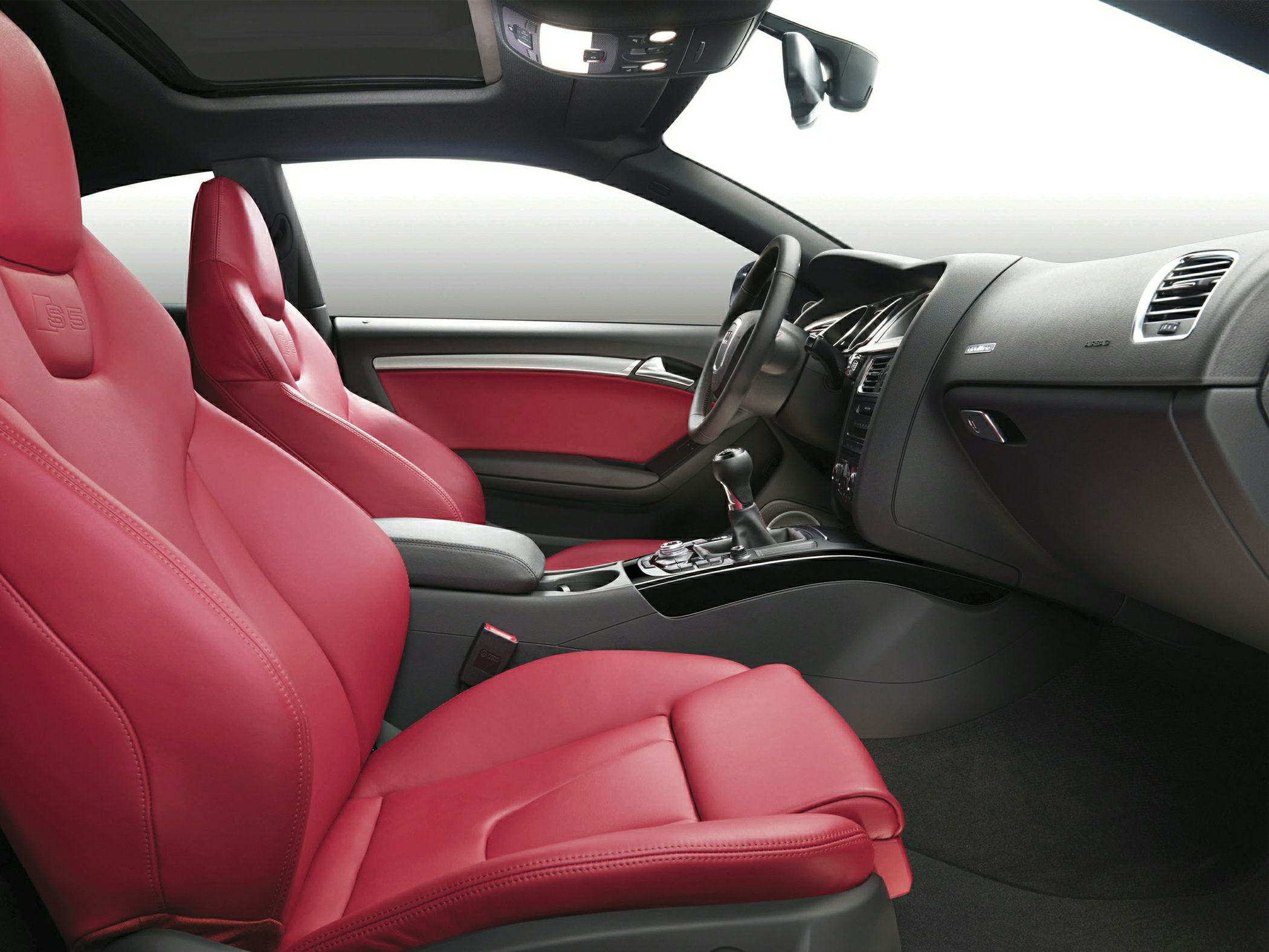 Red leather sport seats and modern dashboard inside vehicle