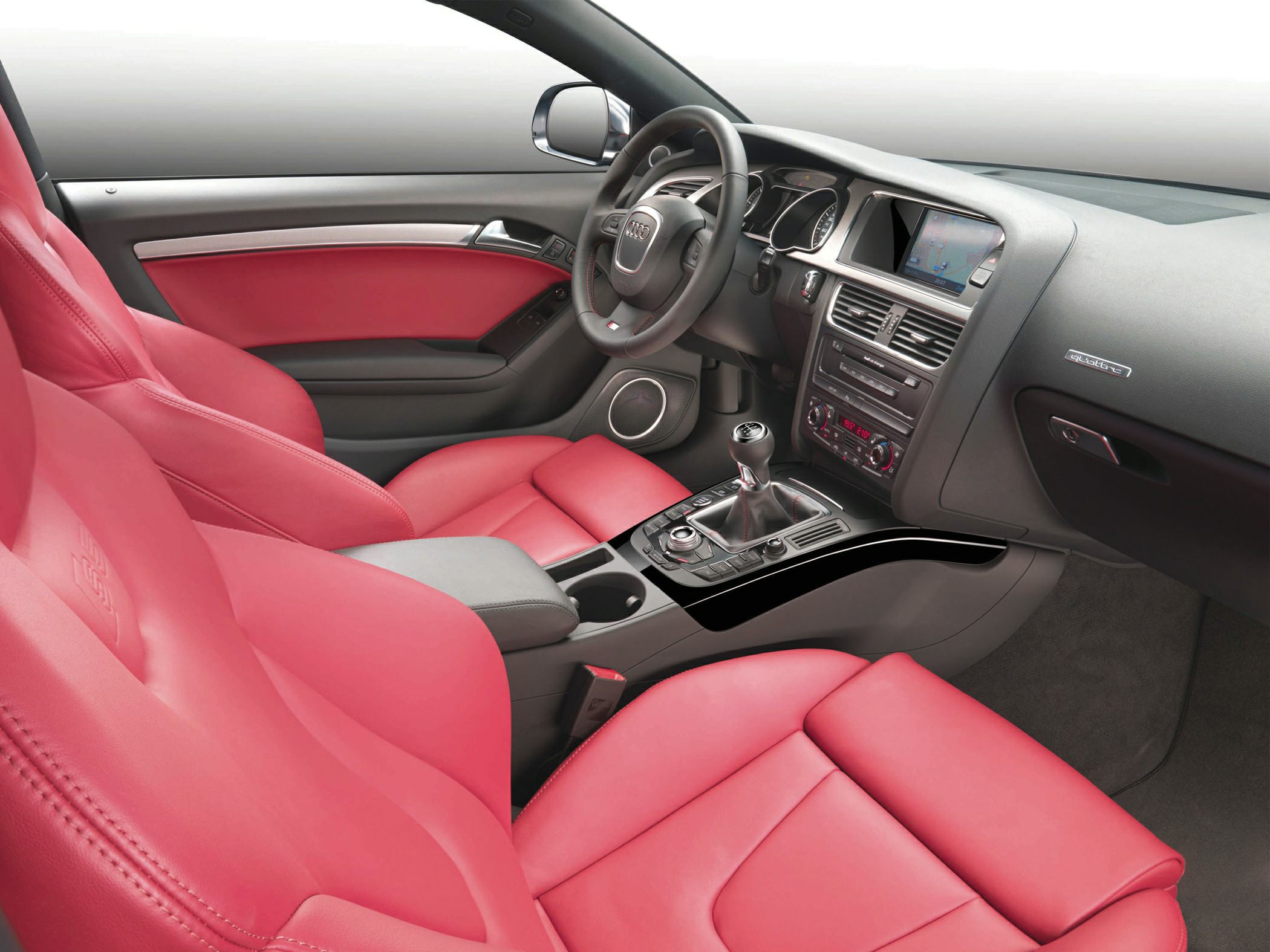 Red leather seats with modern dashboard and manual gearshift
