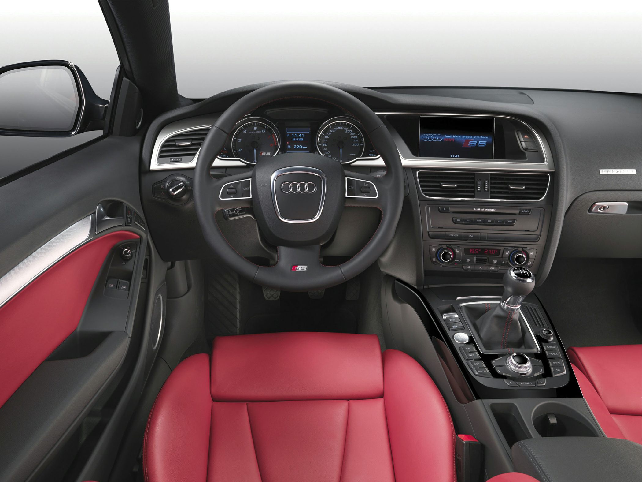 Red leather seats and manual gearshift in luxury convertible interior
