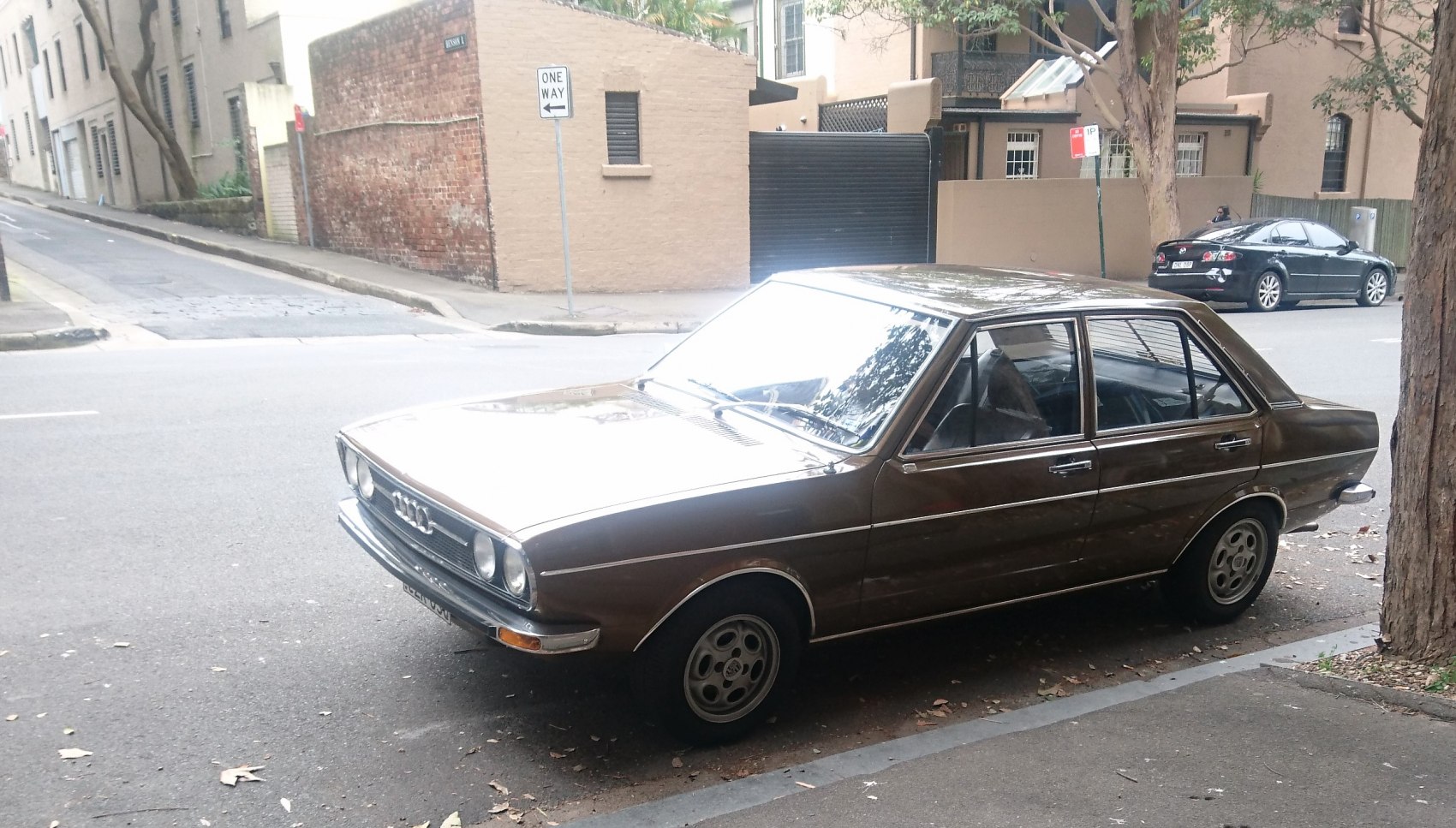 Vintage four-door sedan with quad headlights and chrome accents